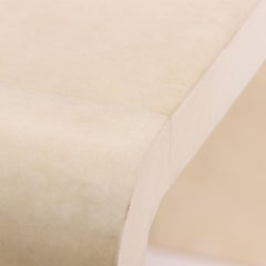 A pair of waterfall parchment covered console tables.