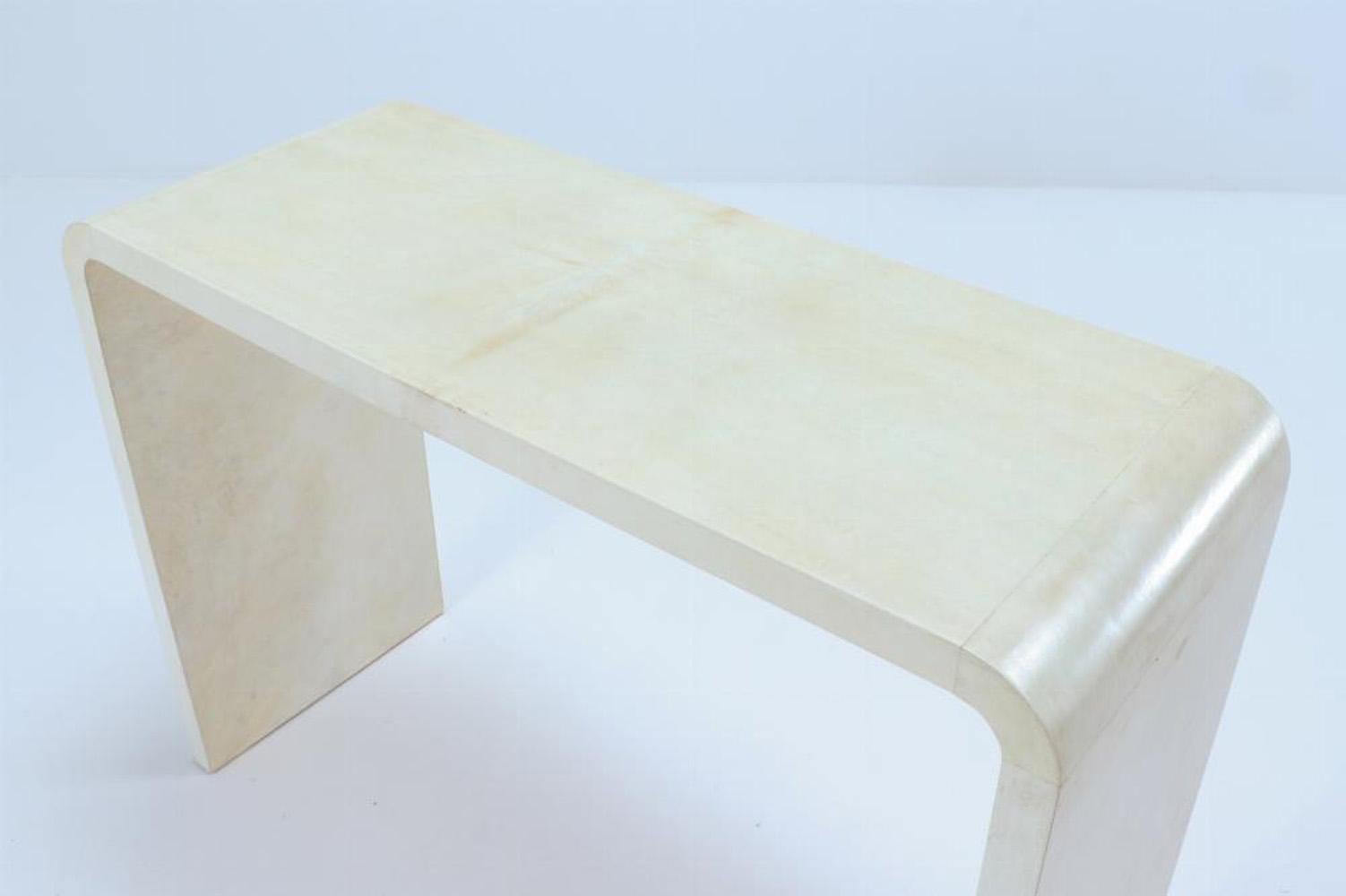A pair of waterfall console tables in the manner of Jean-Michel Frank. 1