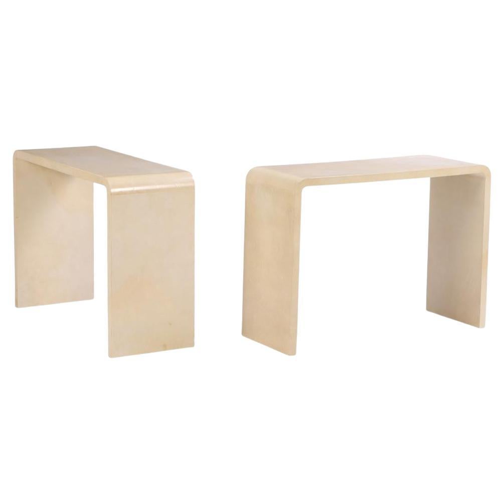 A pair of waterfall console tables in the manner of Jean-Michel Frank.