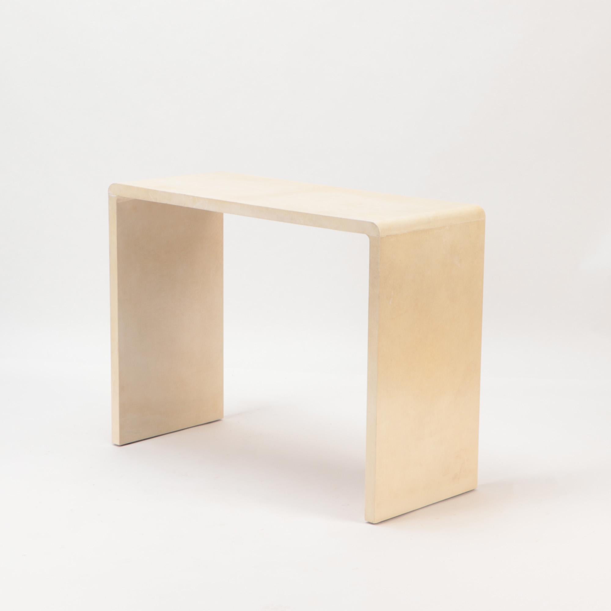 A pair of Jean-Michel Frank style waterfall design parchment console tables. Contemporary.