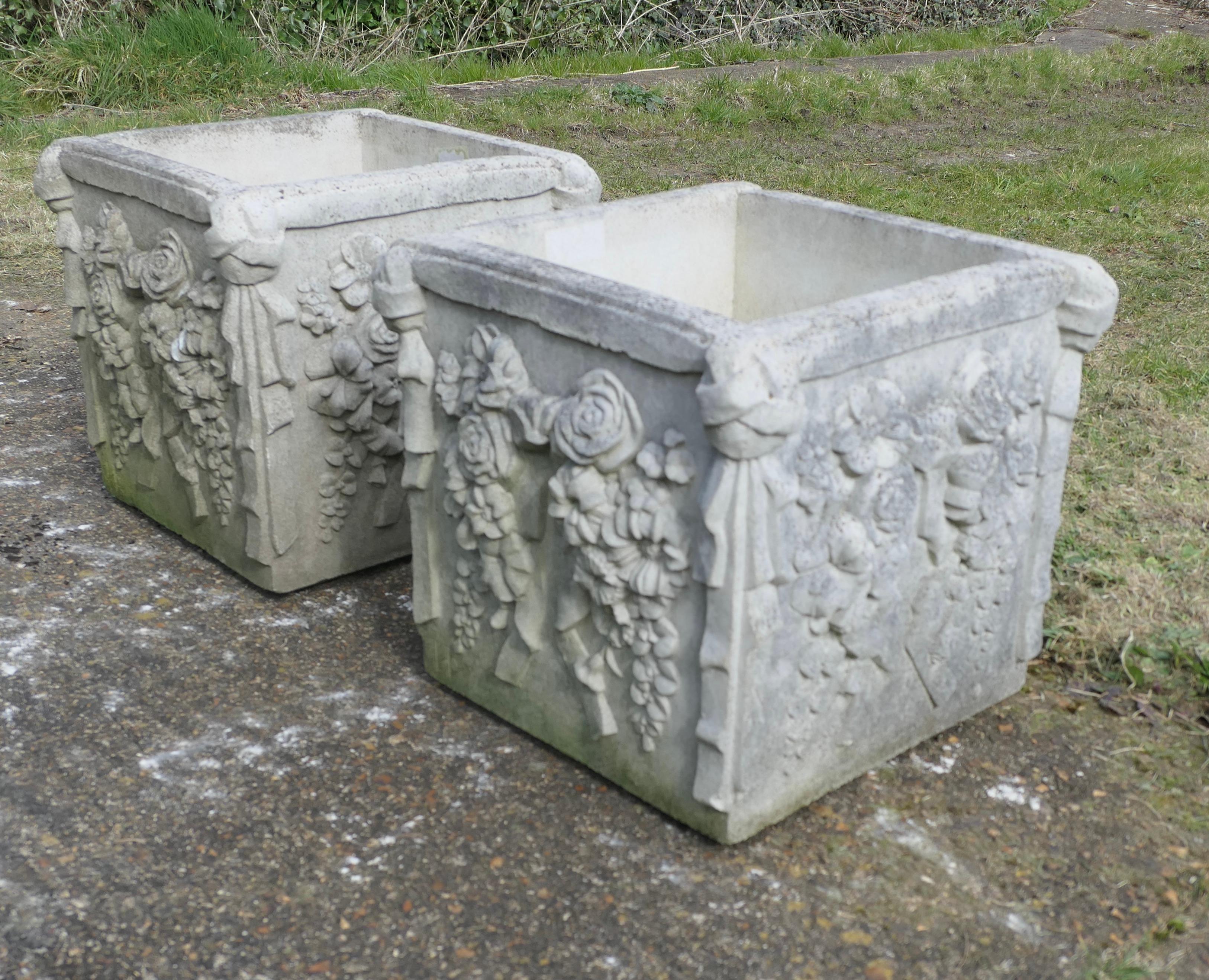 A Pair of Weathered Large Haddonstone Garden Planters

An excellent pair of large square planters, this superb pair is decorated with trailing flowers. 
They are in good condition and well weathered they have a large drainage hole in the centre
The