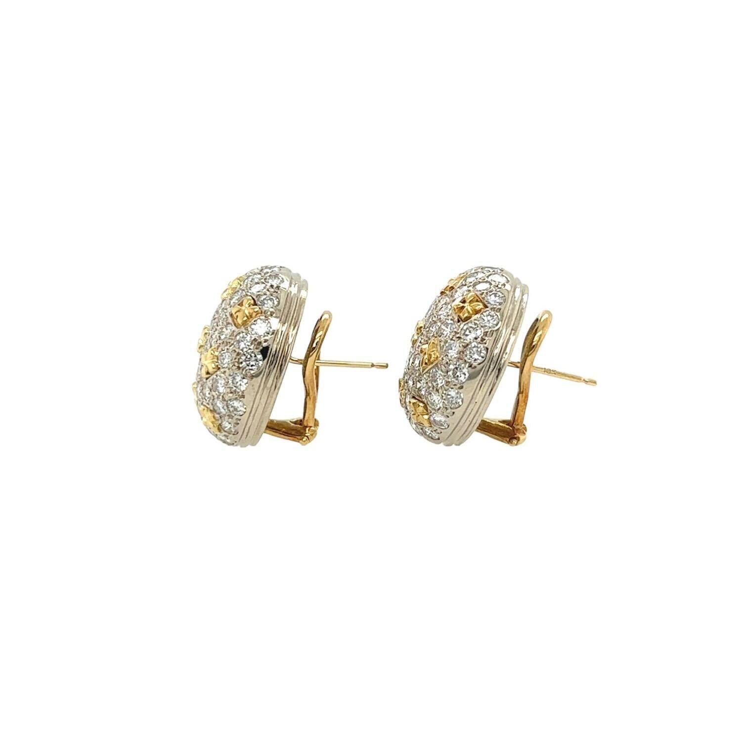 A pair of 18 karat white and yellow gold and diamond earrings.  Each white gold bombe button style earring pave set with approximately fifty seven round brilliant cut diamonds punctuated with nine yellow gold quatrefoils in three rows.  Total