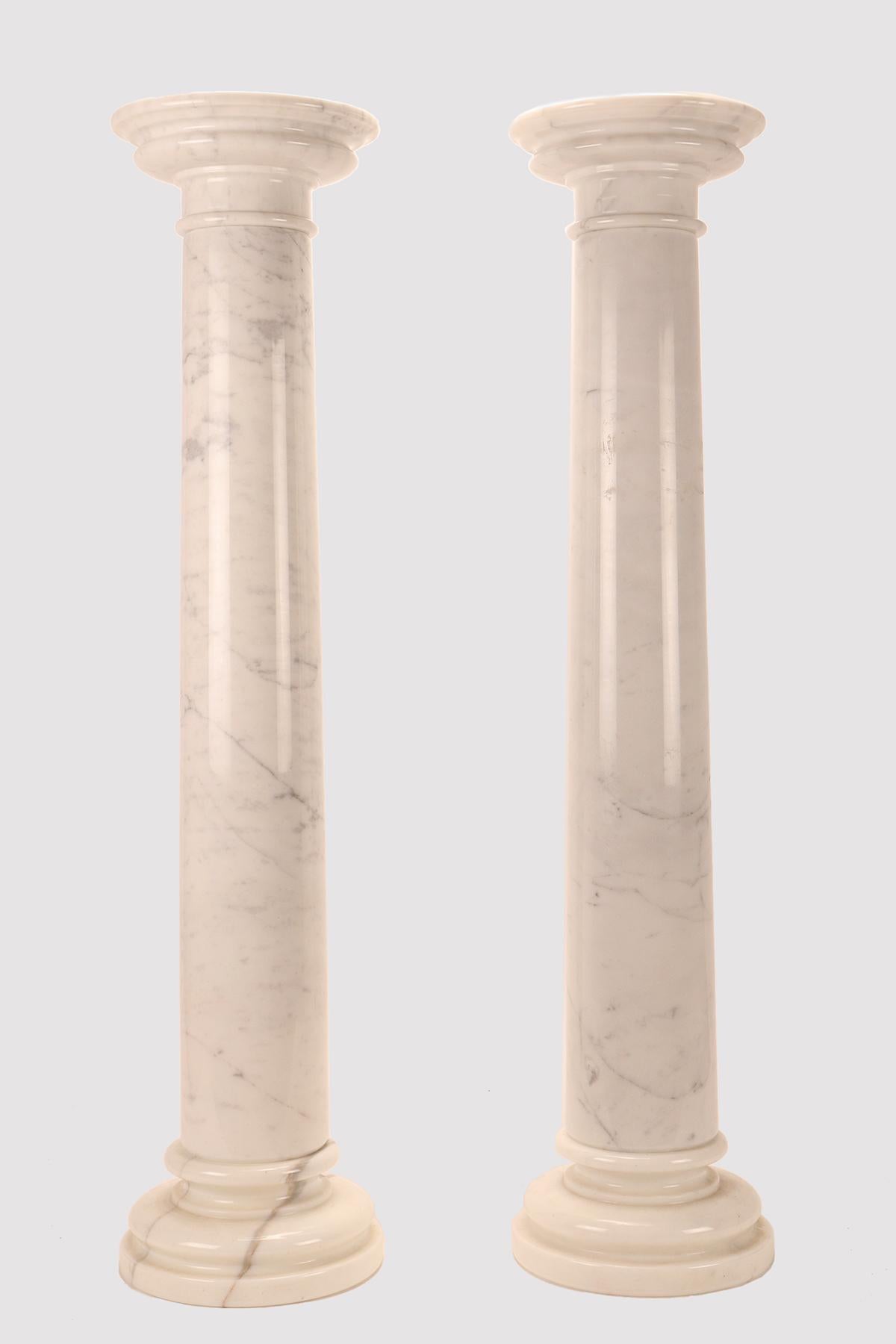 A pair of columns in white Carrara marble.
The columns are sculpted in three distinct elements of white Carrara marble, one for the base, the second for the shaft, the third for the capital. Designed both as a decorative and functional element,