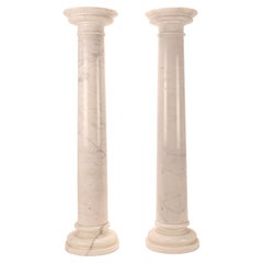 A pair of white Carrara marble columns, Italy 1930s. 