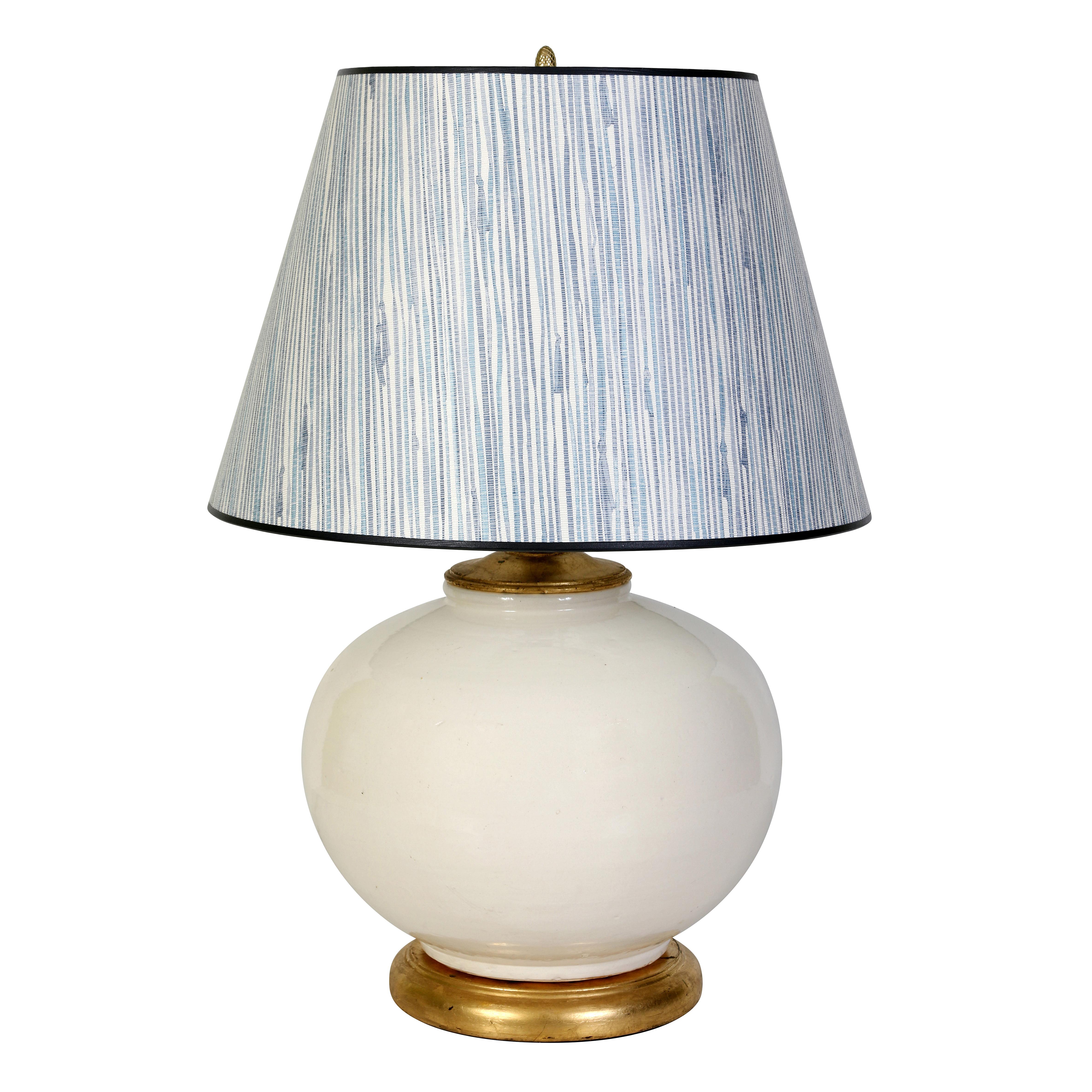 These lamps in a creamy white glaze have a generous, round silhouette on a giltwood base, making them perfect for long console, on the ends of a sofa or on bedside tables or chests.  We have paired them in the shop with blue and white textured