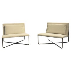 A pair of white Diller chairs designed by Rodolfo Dordoni for Minotti, Italy.