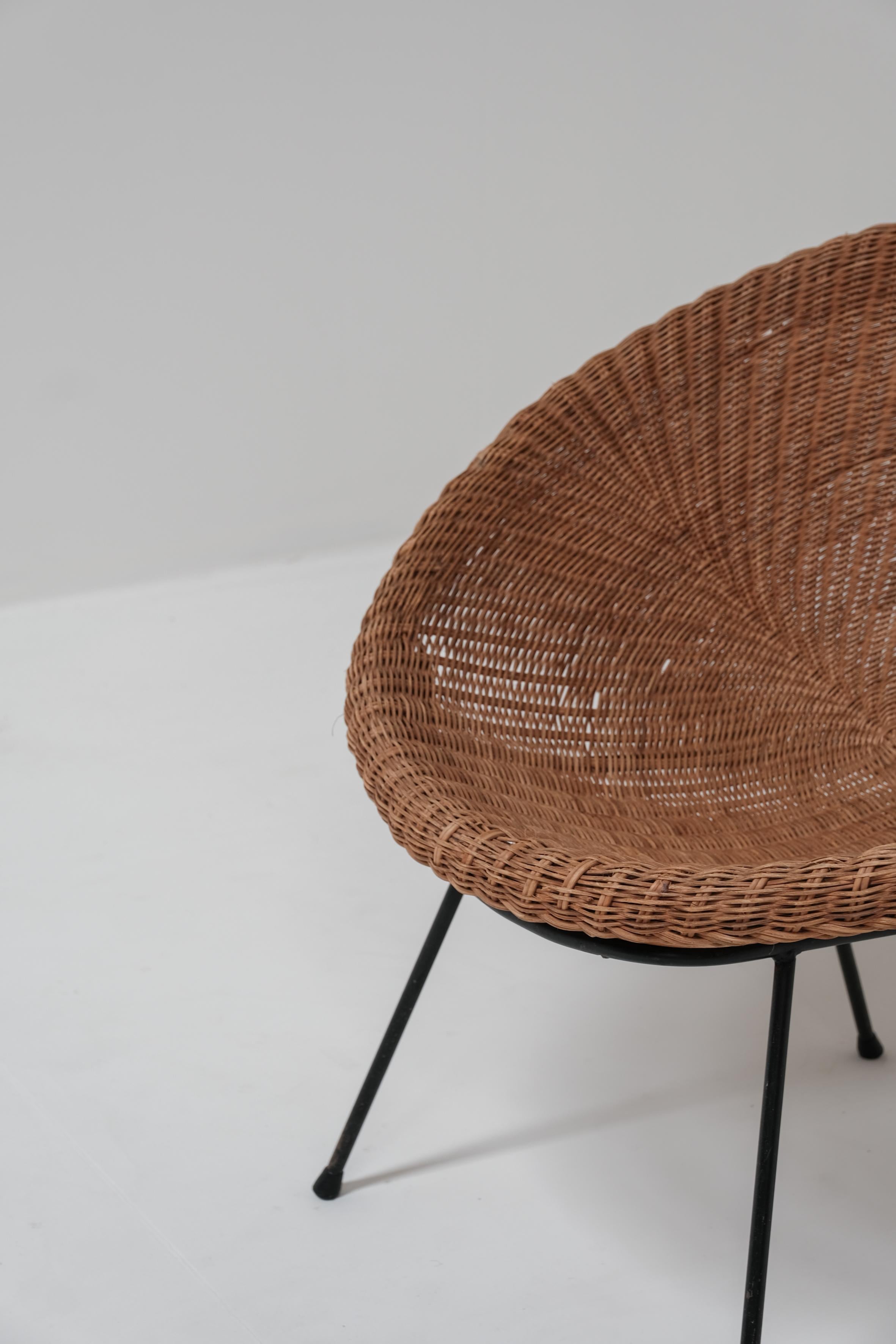A pair of wicker bucket chairs 1970 1