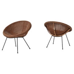 A pair of wicker bucket chairs 1970