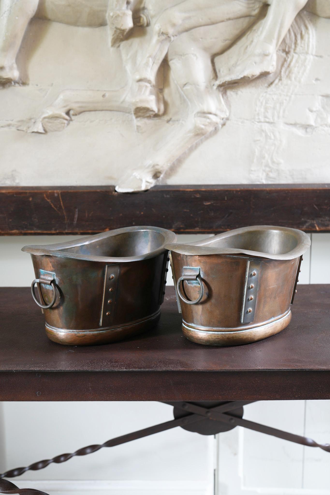 A pair of copper and brass wine coolers with liners in the form of Roman baths by Mead & Company for Liberty of London.

England, circa 1900.

Price is for the pair.
