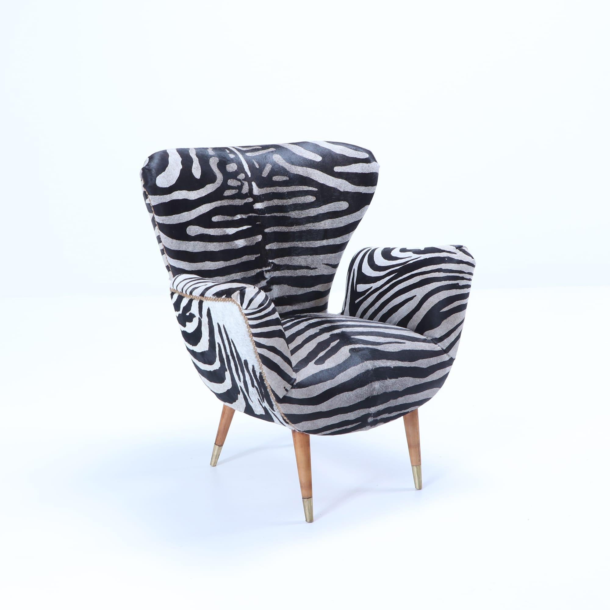A pair of wingback chairs by Paolo Buffa recently upholstered with zebra print leather, circa 1950.