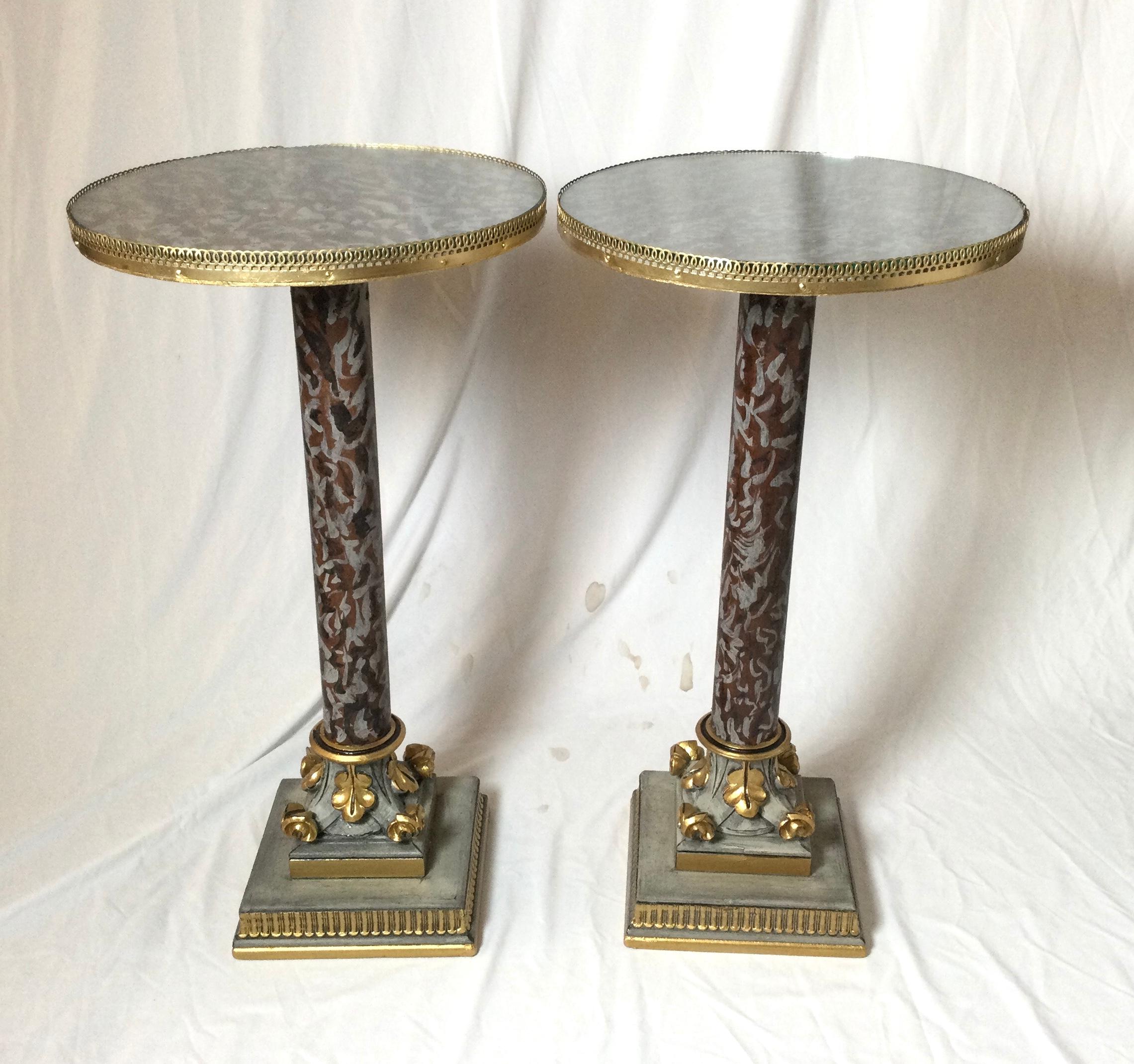 A pair of wooden tables hand painted in a variegated marble with bronze pierced gallery edge. The tops fitted with glass inserts. Continental, early 20th century.