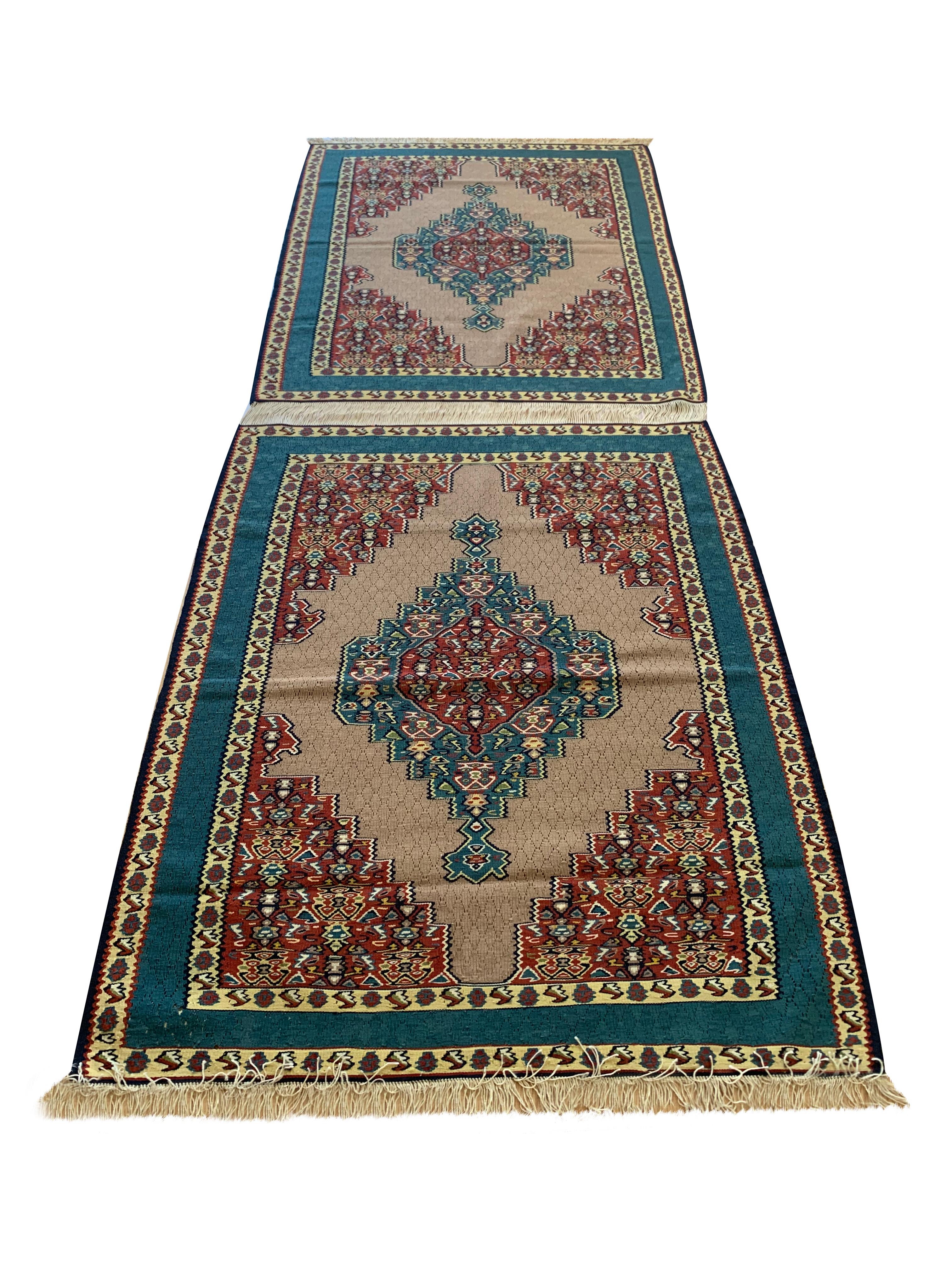 These beautifully handmade wool area rugs are new Kurdish kilim rugs woven in the early 2000s, circa 2010. The central design is highly decorative, featuring geometric medallions woven in broad red and indigo accents on a beige background. The