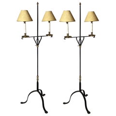 A Pair of Wroght Iron and Brass Adjustable Floor Lamps