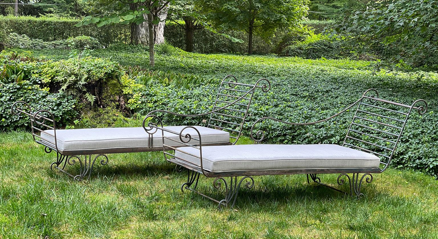 A pair of steel recamiers of neoclassical form, custom-created for the renowned designer Sister Parrish in the mid-1960s, with scrolled high backs, single-sided scrolled arms and scrolled feet, paired with new rectangular cushions upholstered with