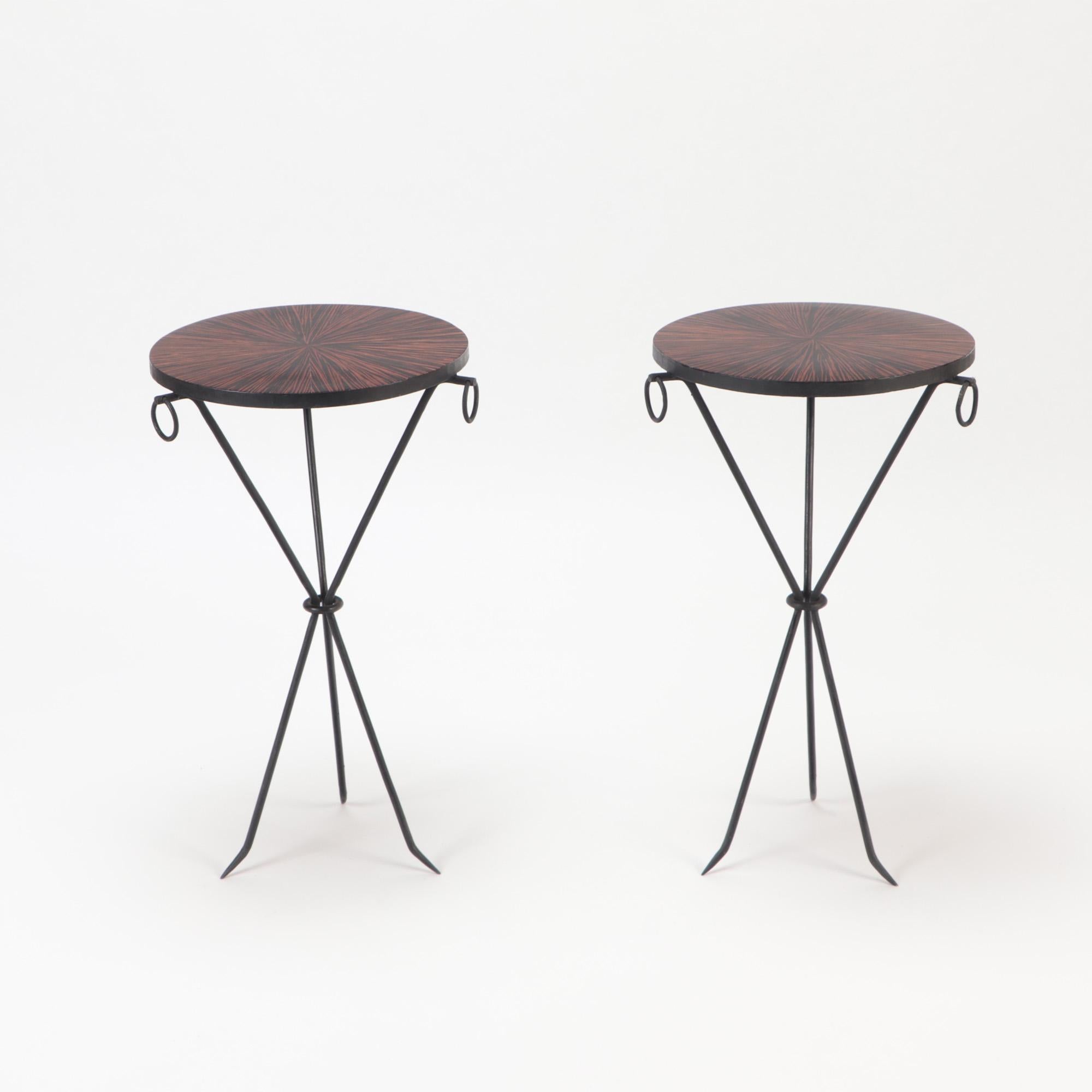  A pair of wrought iron drink tables with parquet tops and three iron rings. in the manner of Jean-Michel Frank. The tables rest on a sleek tripod form base.