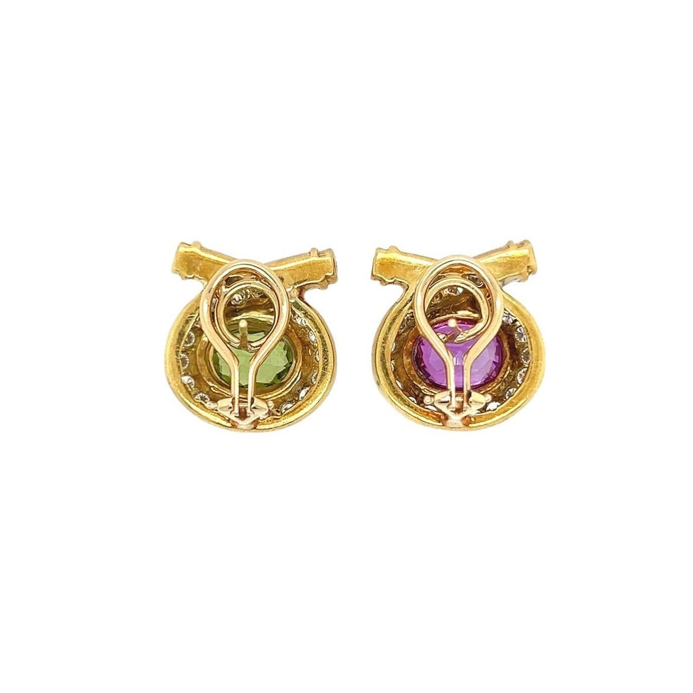 A pair of 18 karat yellow and white gold, peridot, pink tourmaline and diamond earrings.  The first yellow gold earring centering a bezel set oval faceted peridot measuring approximately 8.72 x 6.43 mm within a crossover surround of approximately