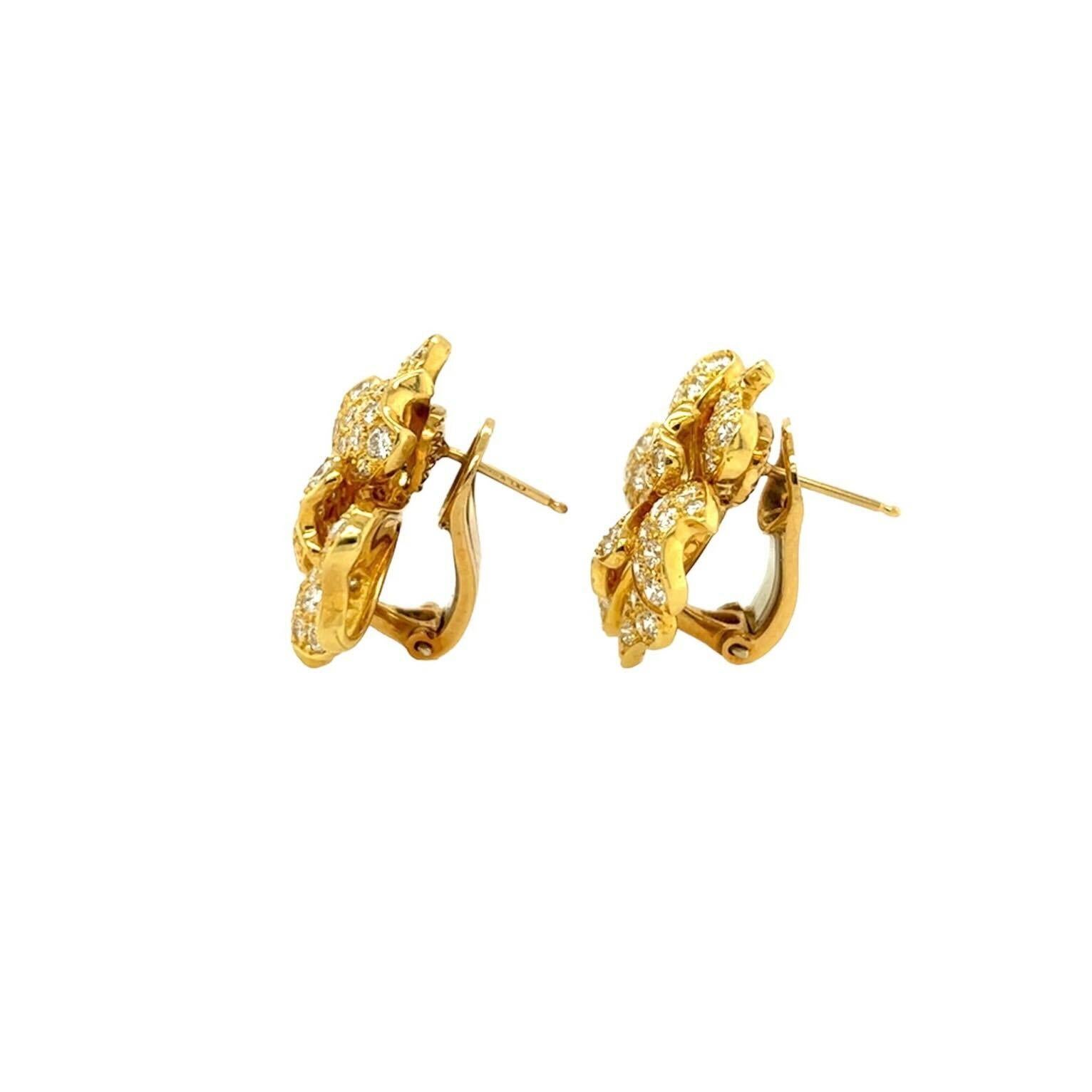 A pair of 18 karat yellow gold and diamond earrings.  Each earring designed as a flower, the petals pave set with approximately eighty seven brilliant cut diamonds.  Total diamond weight approximately 6.26 carats.  Length approximately 1 inch. 