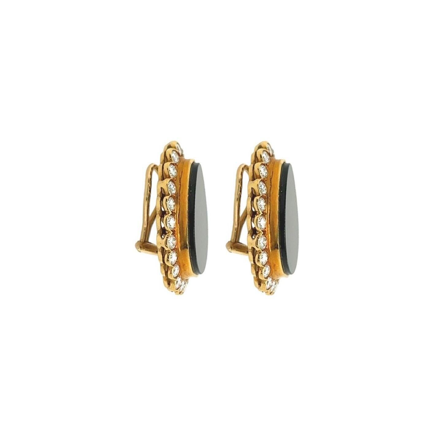 A pair of 18 karat yellow gold, black onyx and diamond earclips.  Each earclip designed as bezel set drop shaped black onyx plaque surrounded by twenty two (22) bezel set round brilliant cut diamonds.  Total diamond weight approximately 3.03 carats.