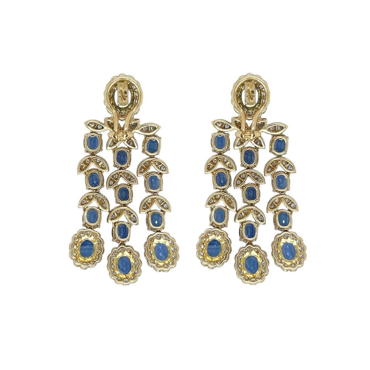 A pair of 18 karat yellow gold, sapphire and diamond earrings.  Each chandelier style earring set at the top with an oval faceted sapphire measuring approximately 7.89 x 5.72 mm surrounded by fourteen (14) round brilliant cut diamonds suspending a