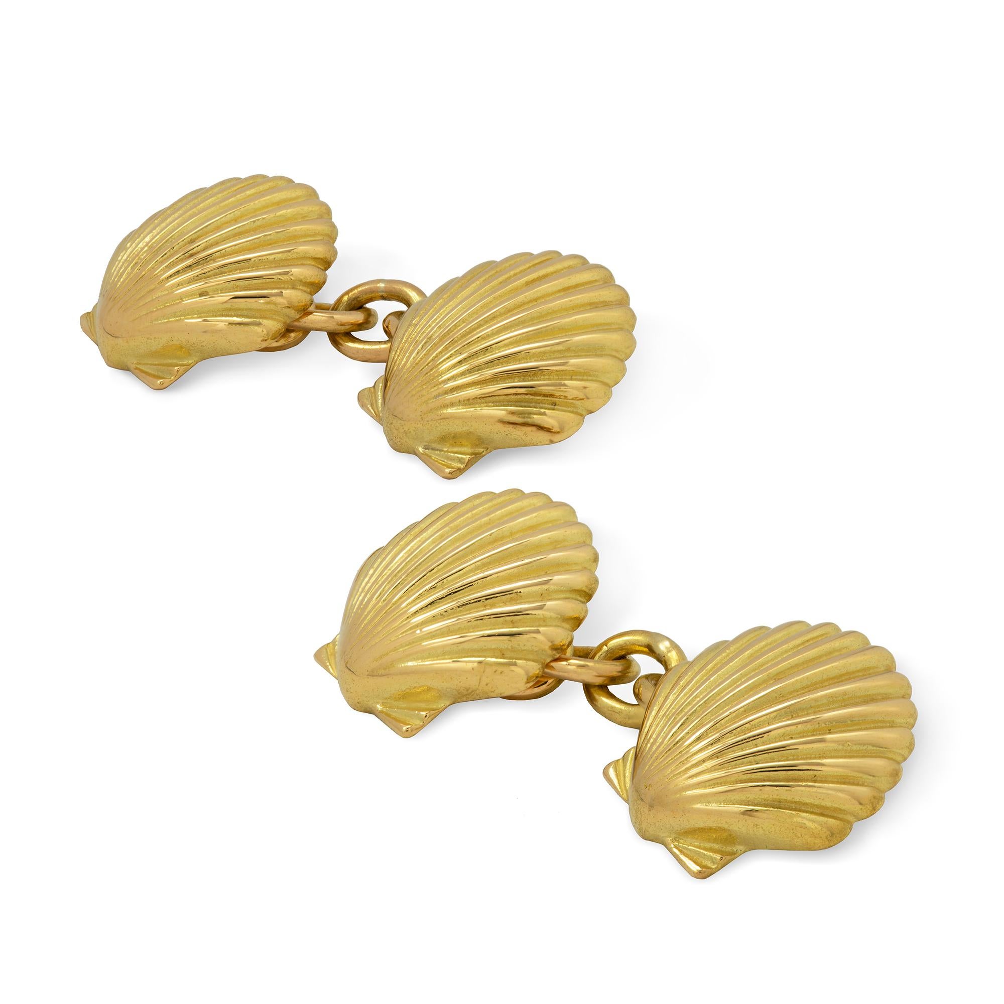 A pair of yellow gold shell cufflinks, each with two solid gold carved shells with chain link connections between, later  hallmarked 18ct gold London 2018, bearing the Bentley& Skinner sponsor mark, measuring approximately 1.3cm in diameter, gross