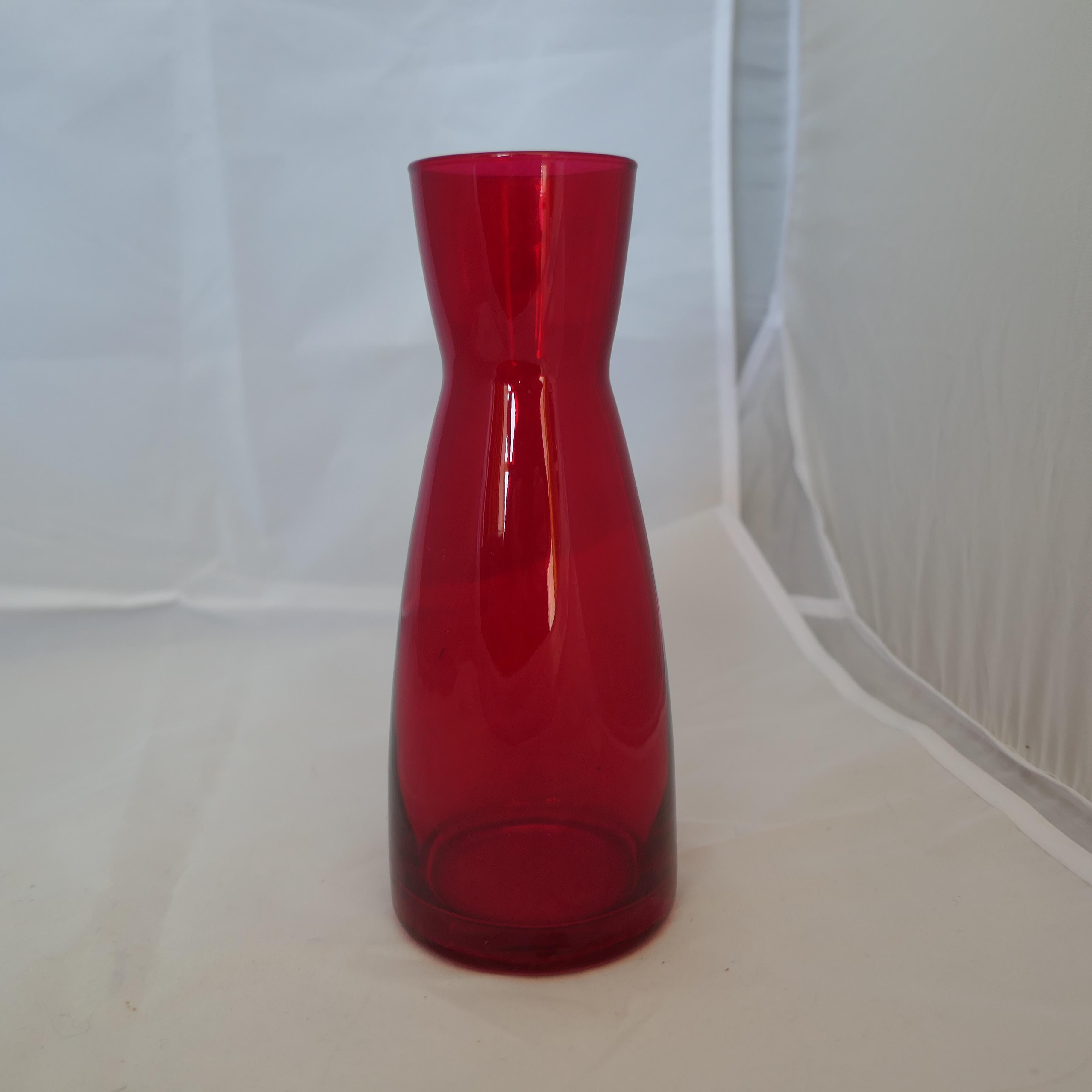 A Pair of Ypsilon Red Glass Carafes by Bormioli Rocco 

Beautiful red glass carafes by Bormioli Rocco made in Italy.  
These are the Ypsilon carafes they are tall and elegant with a tapered body into a nice mouth for easy pouring. 
The Perfect Pair