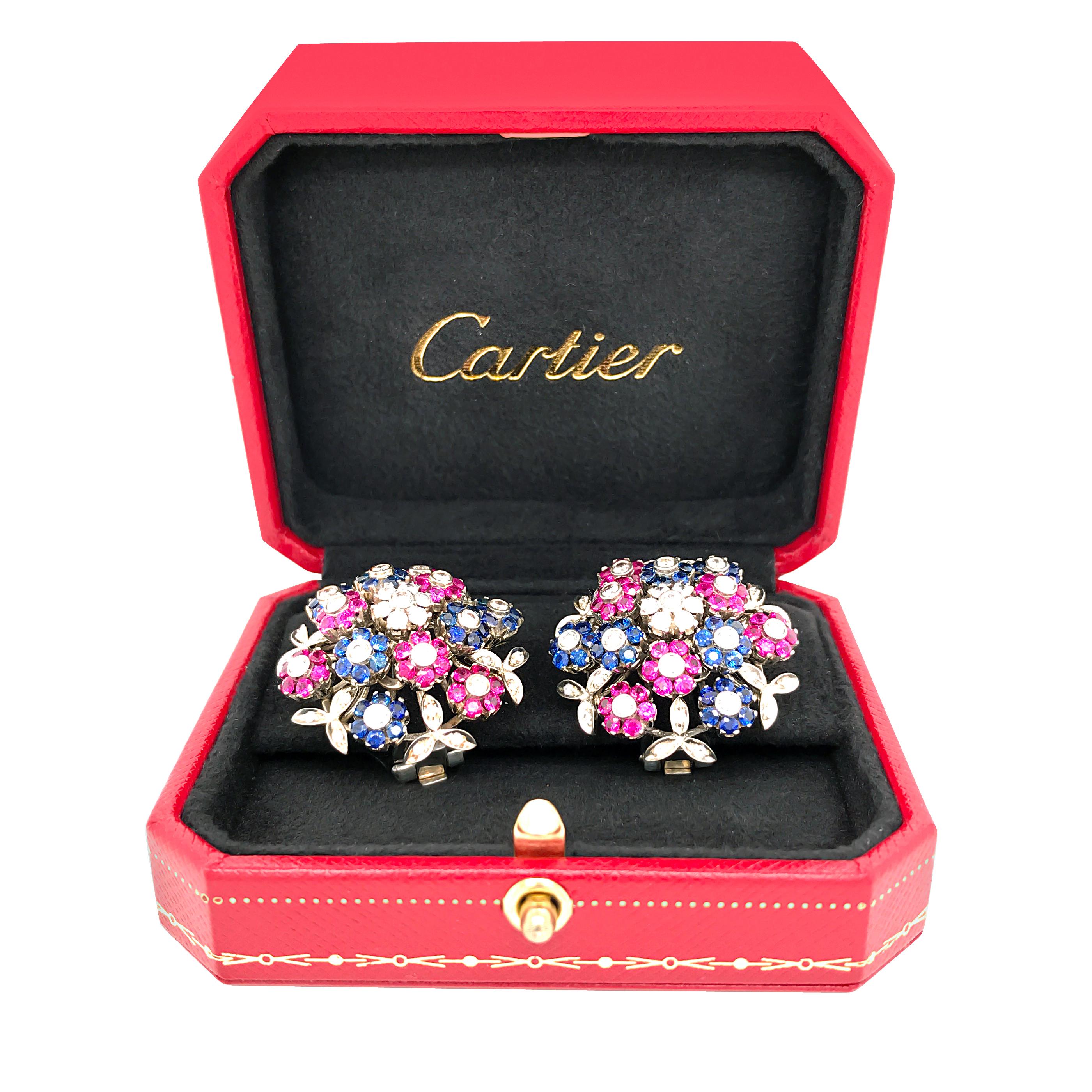 The Cartier earrings designed as bouquets, set en tremblant with brilliant-cut diamonds, rubies and sapphires;signed Cartier, French Mark, estimated total diamond weight: 1.80 carats, Sapphire 1.4 carat and Ruby 1.4 carar, mounted in 18k white gold;