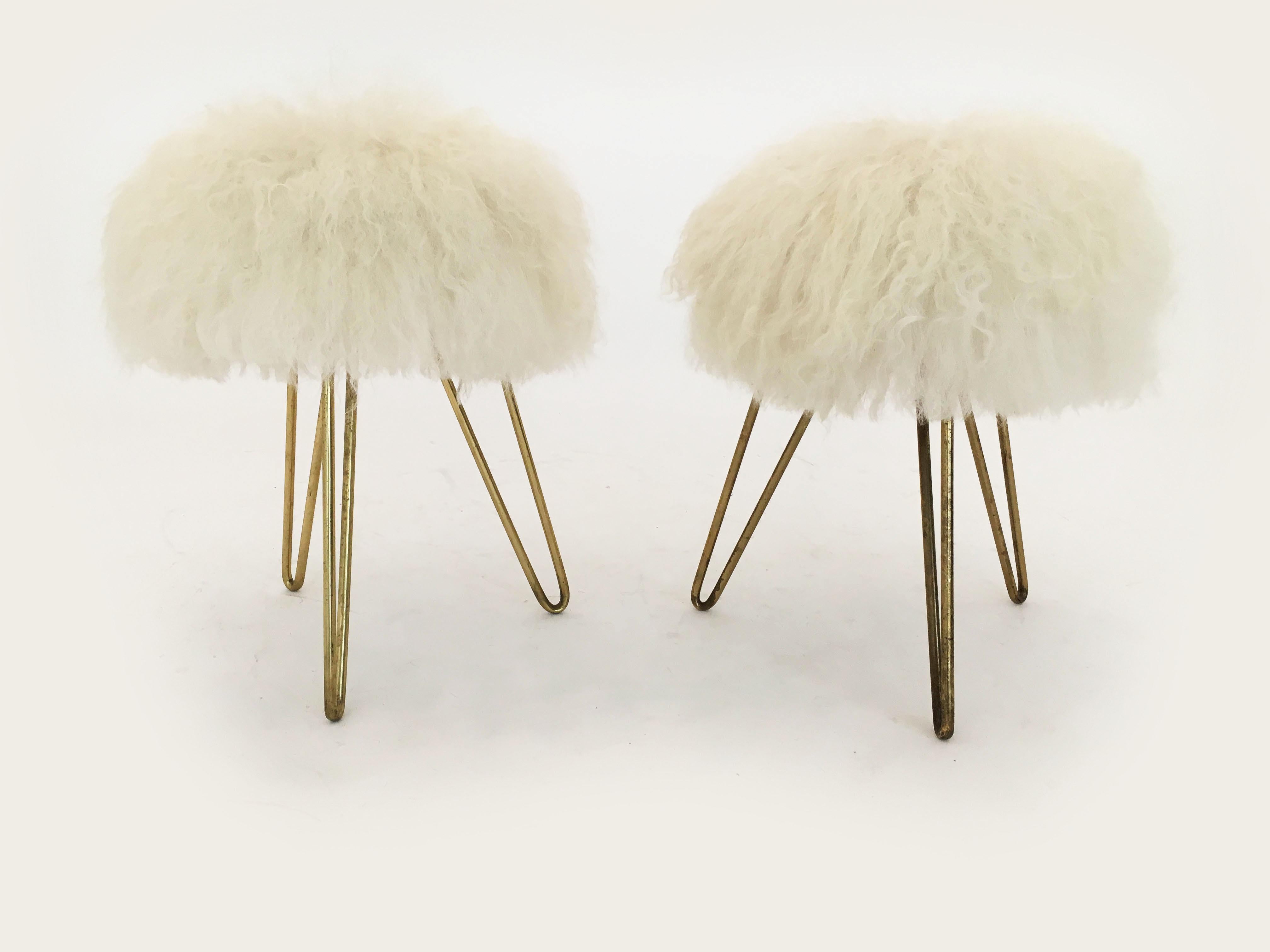 Delightful pair of sheep fur stools, France, 1950s. In excellent vintage condition with just the right amount of gently aged patina on the hair pin brass legs. The fur is clean and firm almost like new, although truly vintage from the 1950s and has