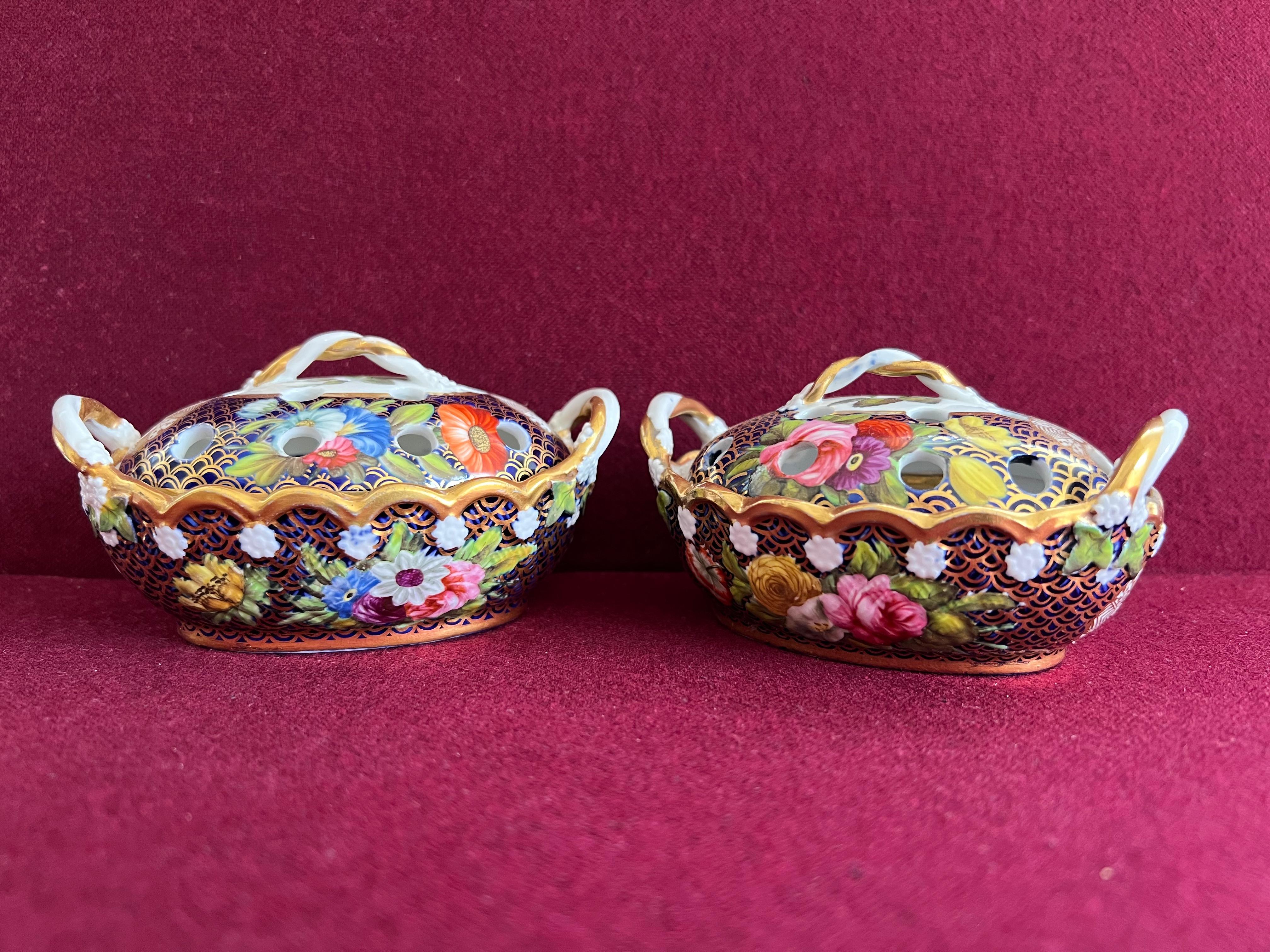 A fine pair of Spode Violet Pot Pourri baskets and covers c.1815-20. Of oval shape with rope-twist handles and finials, the domed covers pierced, painted with pattern 1166. One of the most sumptuous designs produced has pattern number 1166.  Pattern