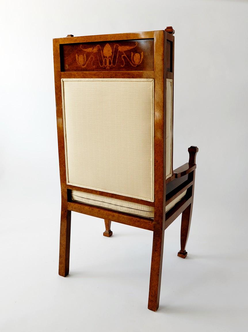 The high back inlaid with lotus leaves and Egyptian motifs on front and rear, designed by Carl Malmsten.