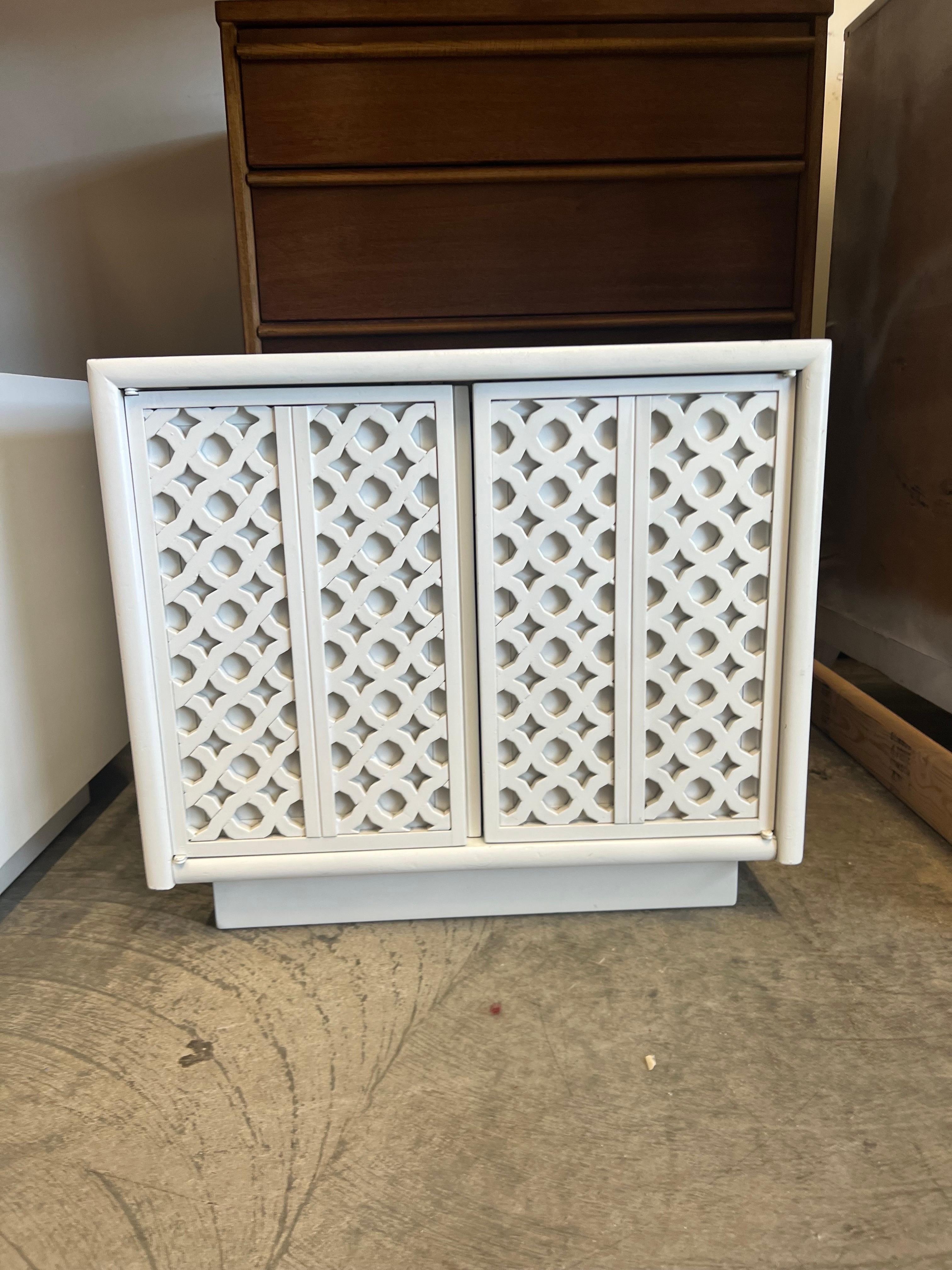 I like to think of these as the breeze blocks end tables/nightstands. They have a funky weave design on the front. The double door cabinet style nightstands open to reveal one adjustable shelf. Lacquered in gloss white.