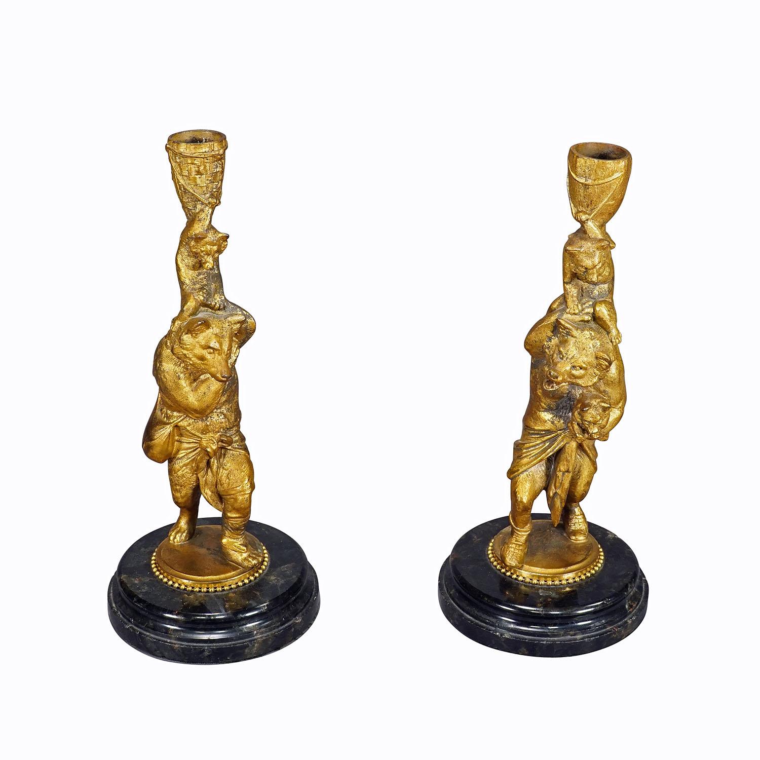 A Pair Victorian Casted and Gilded Iron Candle Stick with Bears

A pair great Victorian casted iron candle sticks with gilded finish and marble base, Germany circa 1860. Each depicting a mother bear carrying her cubs. The art cast was manufactured