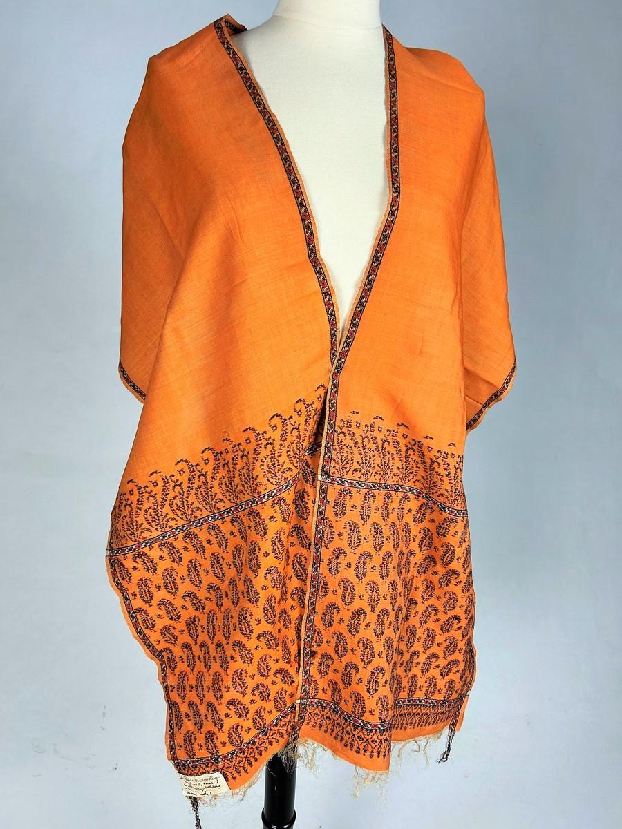 Second half of the 19th century
Scotland

Delightful Cashmere or Paisley woven wool scarf of British origin, dating from the Victorian period. Spectacular Saffron-orange color with boteh on both ends, neo-Gothic style borders with tapered bangs.