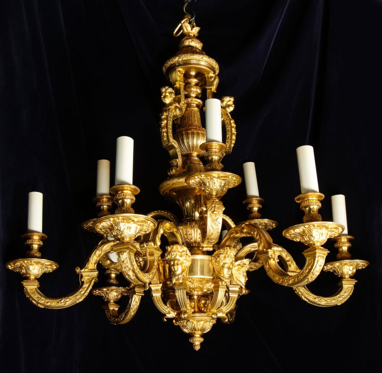 A palatial and large antique French Louis XVI gilt bronze figural double tier multi light chandelier of exquisite craftsmanship embellished with the most intricate detail and further adorned with figural masks.
