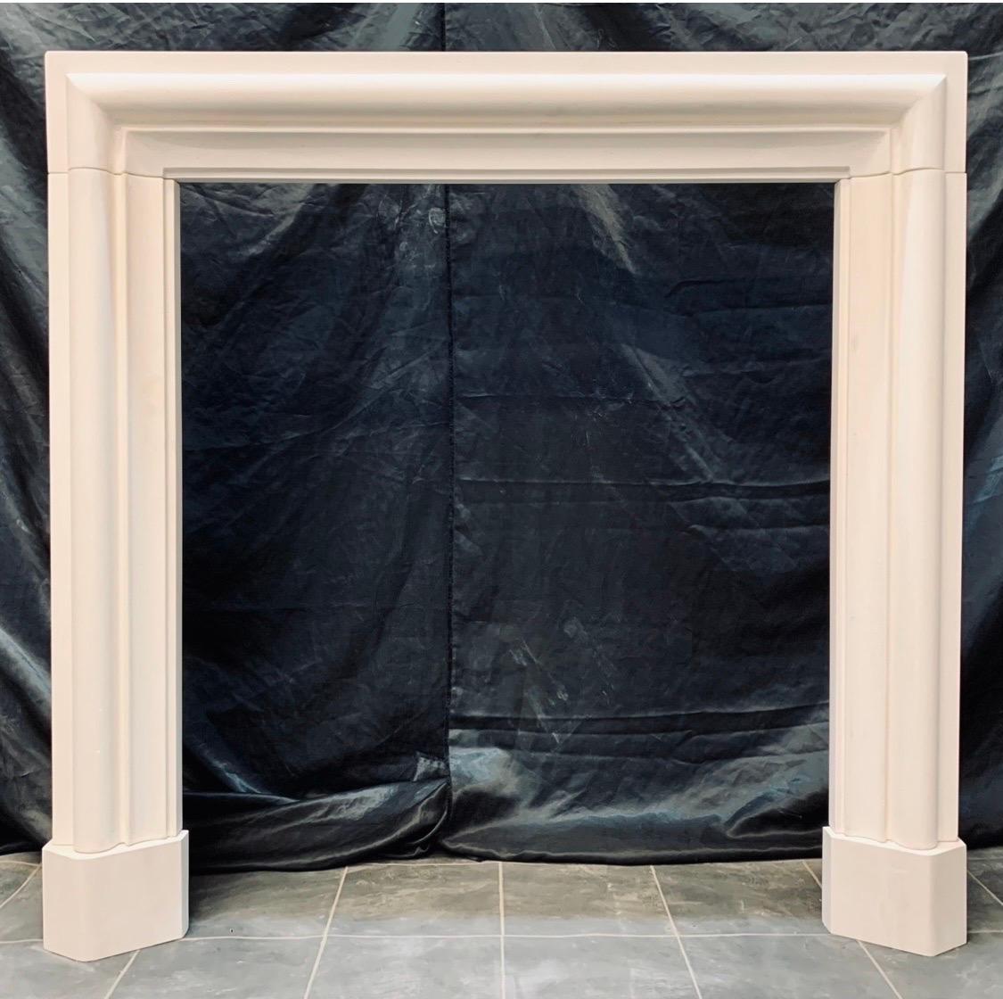 A tall and versatile Palladian manner solid Limestone fireplace surround. A generous moulded top shelf sits above a cushion spacer set with a central unadorned tablet (the whole removable) this in turn rests on a bolection moulded frieze lintel-