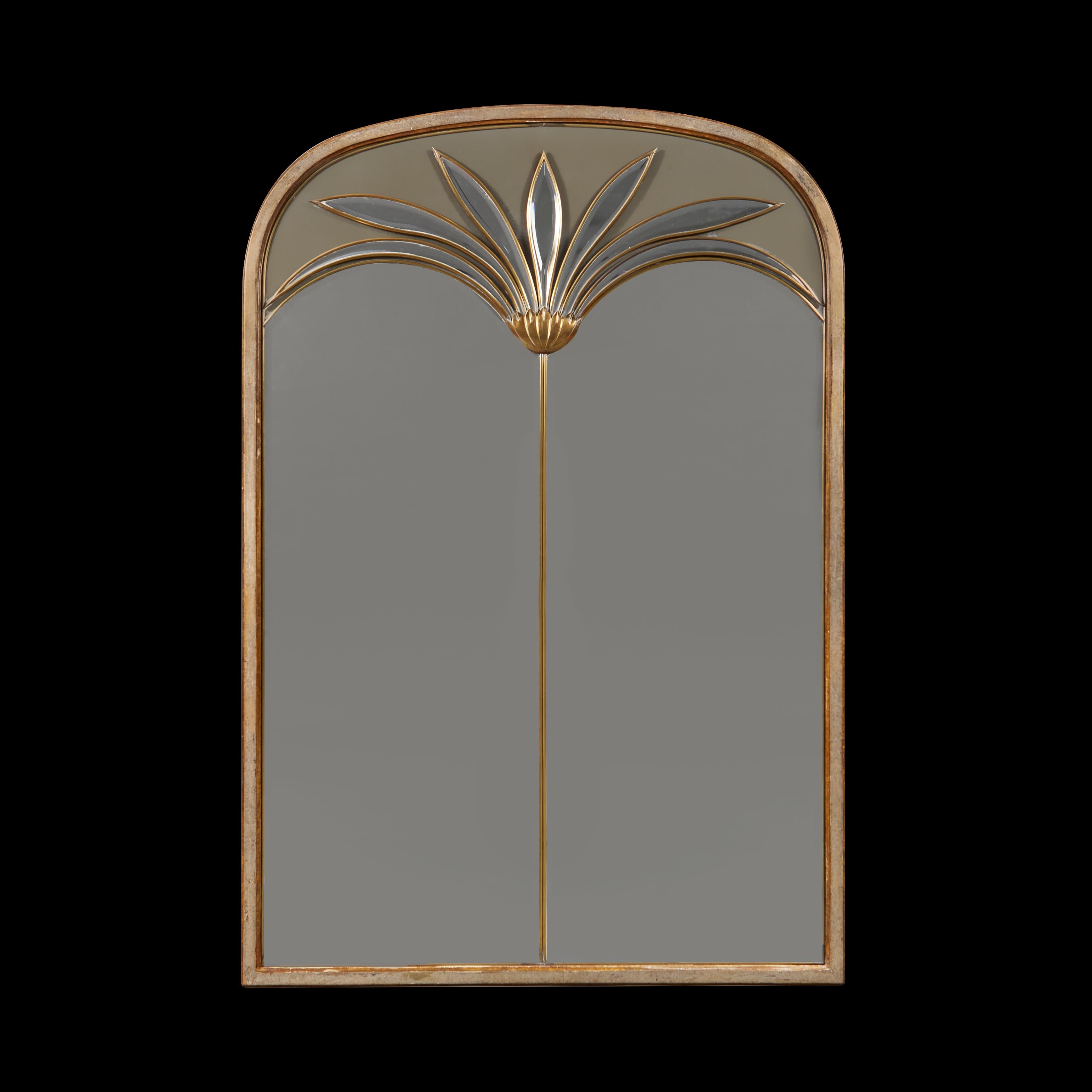 Italy, circa 1970

An unusual mirror of large scale with applied brass palm fronds, on a split bevel plate, with arched pediment, all within a silver gilt fame.

Height  134.00cmm
Width    92.00cm
