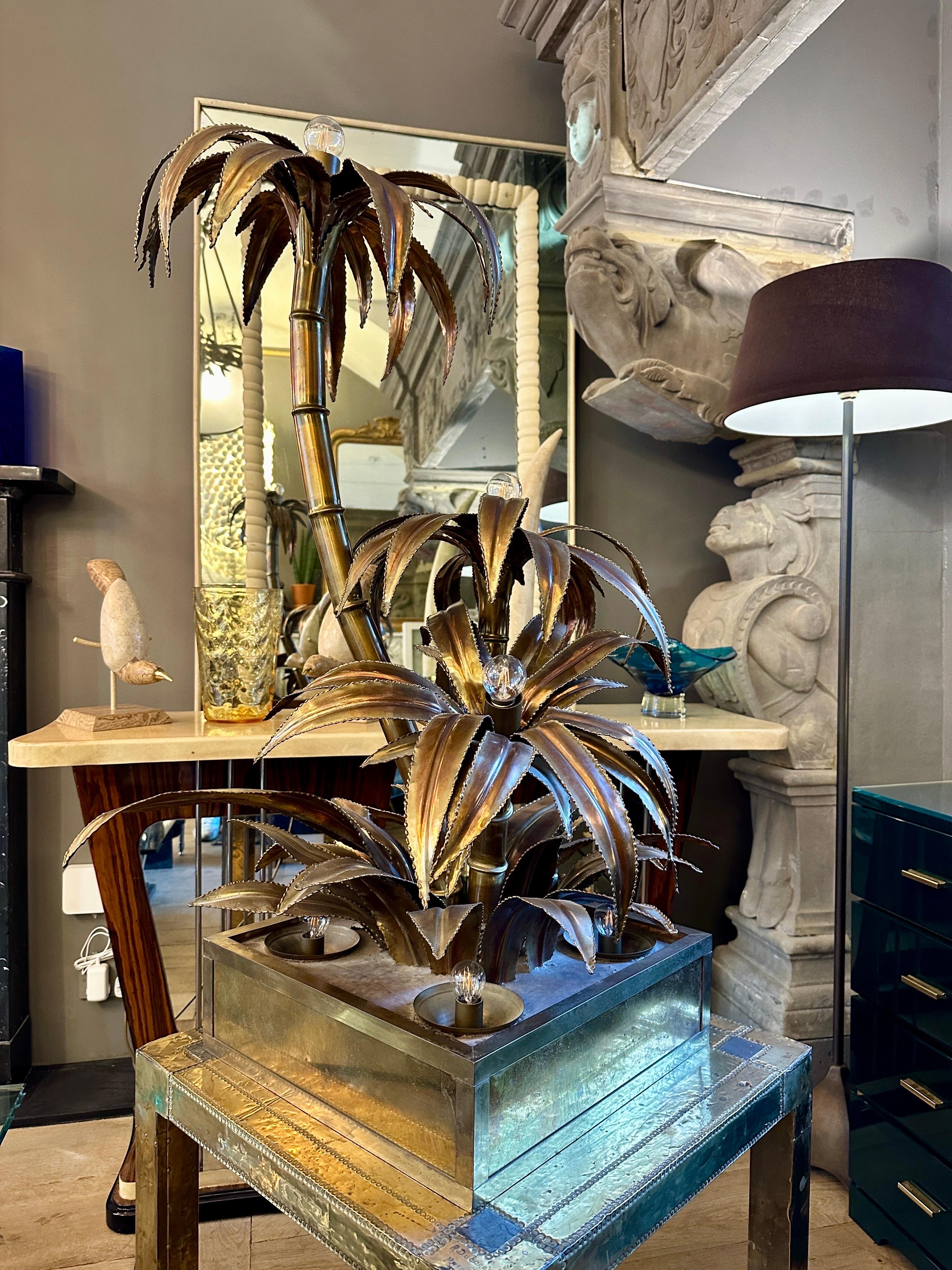 A 3 arm palm tree floor lamp by Maison Jansen in brass with large square base with 4 up lighters within. Could also be used as a very large table lamp as shown in images. The base with large leaves supporting the 3 arm stems in brass with large leaf