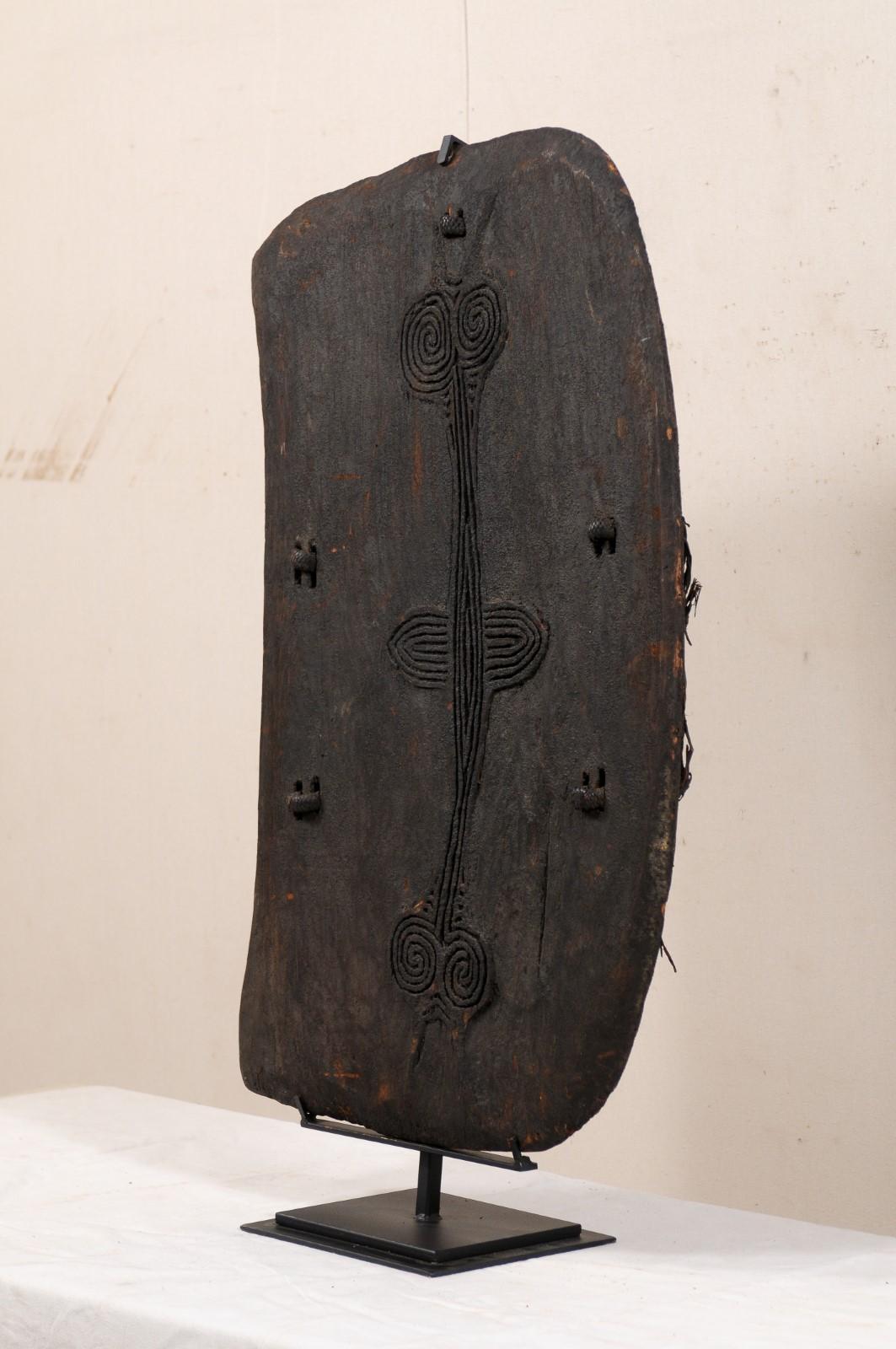 20th Century Papua New Guinea Carved-Wood Lumi Shield on Custom Iron Stand For Sale