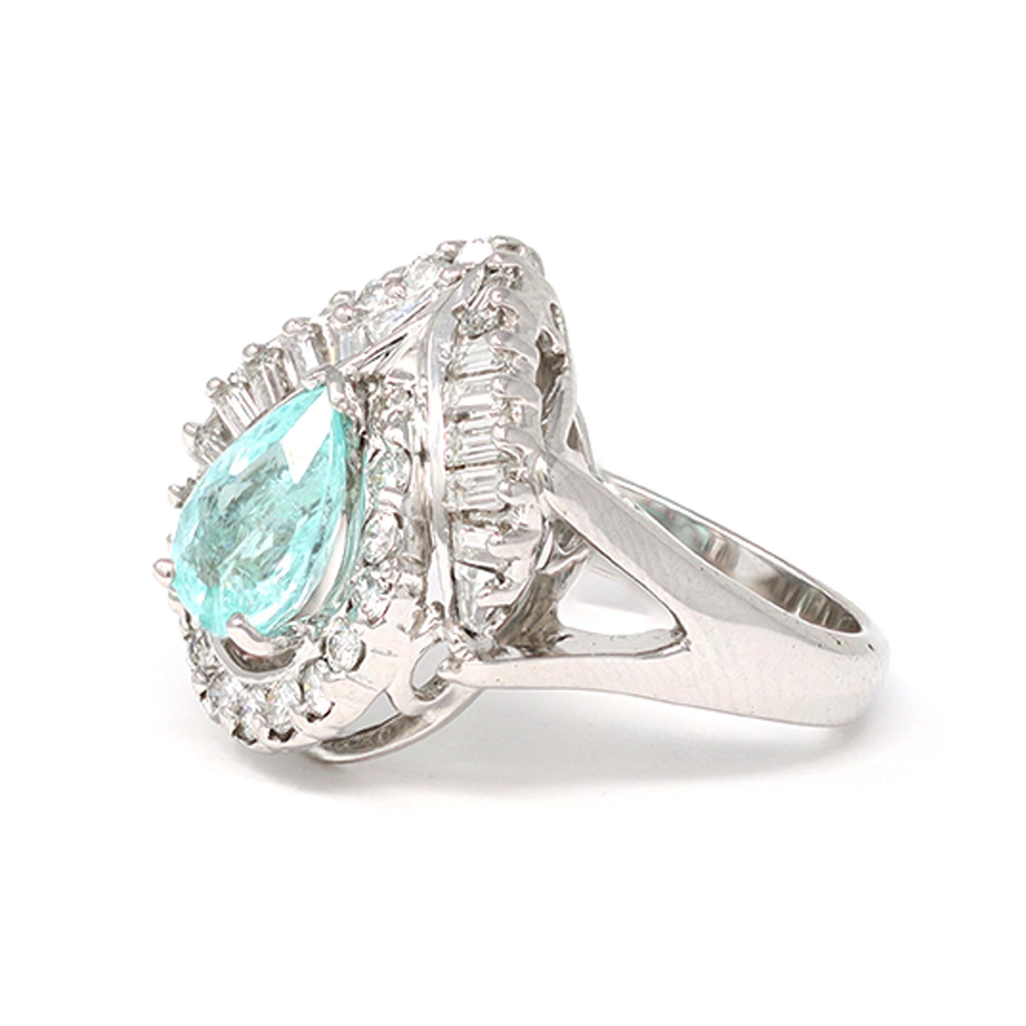 A striking pear-shaped Paraiba tourmaline and diamond ring circa 1990. The vivid turquoise Paraiba Tourmaline weighs 1.26 carats. It is adorned with mixed-cut diamonds. The estimated weight of the diamonds is 0.83 carats, with a grade of GH color