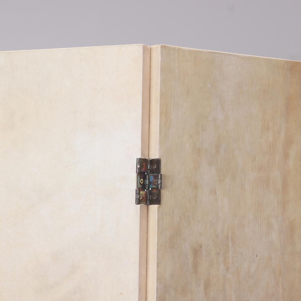 Contemporary A parchment covered three panel folding screen.