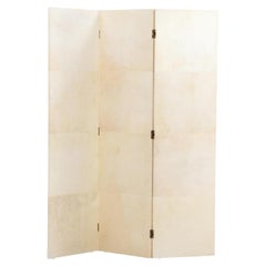A parchment covered three panel folding screen.