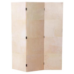 A parchment covered three panel folding screen.