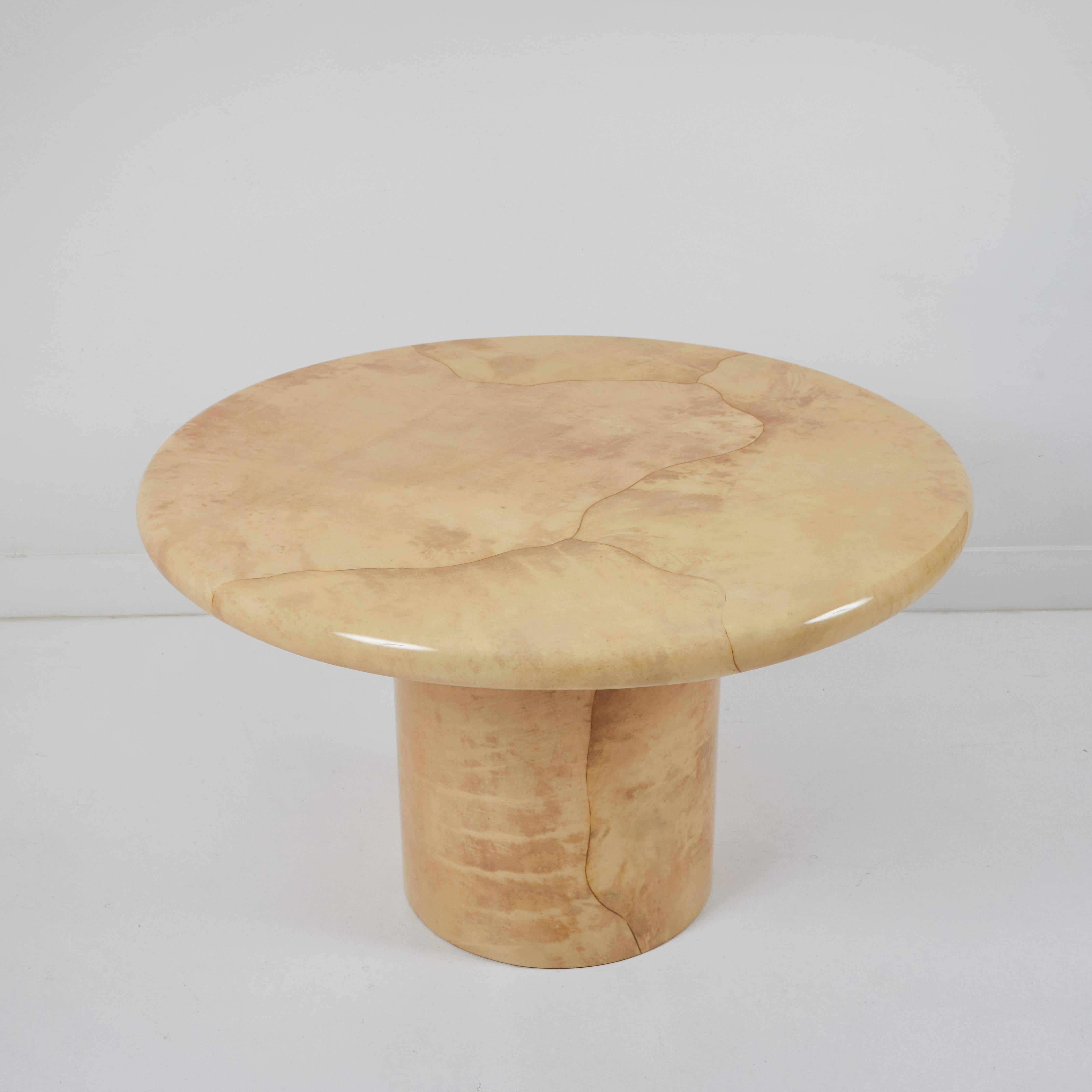 Beautiful pedestal table designed by Karl Springer and manufactured in 1985. this table exhibits all the classic features of Springer's work from the 1980s. the freeform application of the parchment, the very substantial bullnose edge of the top and