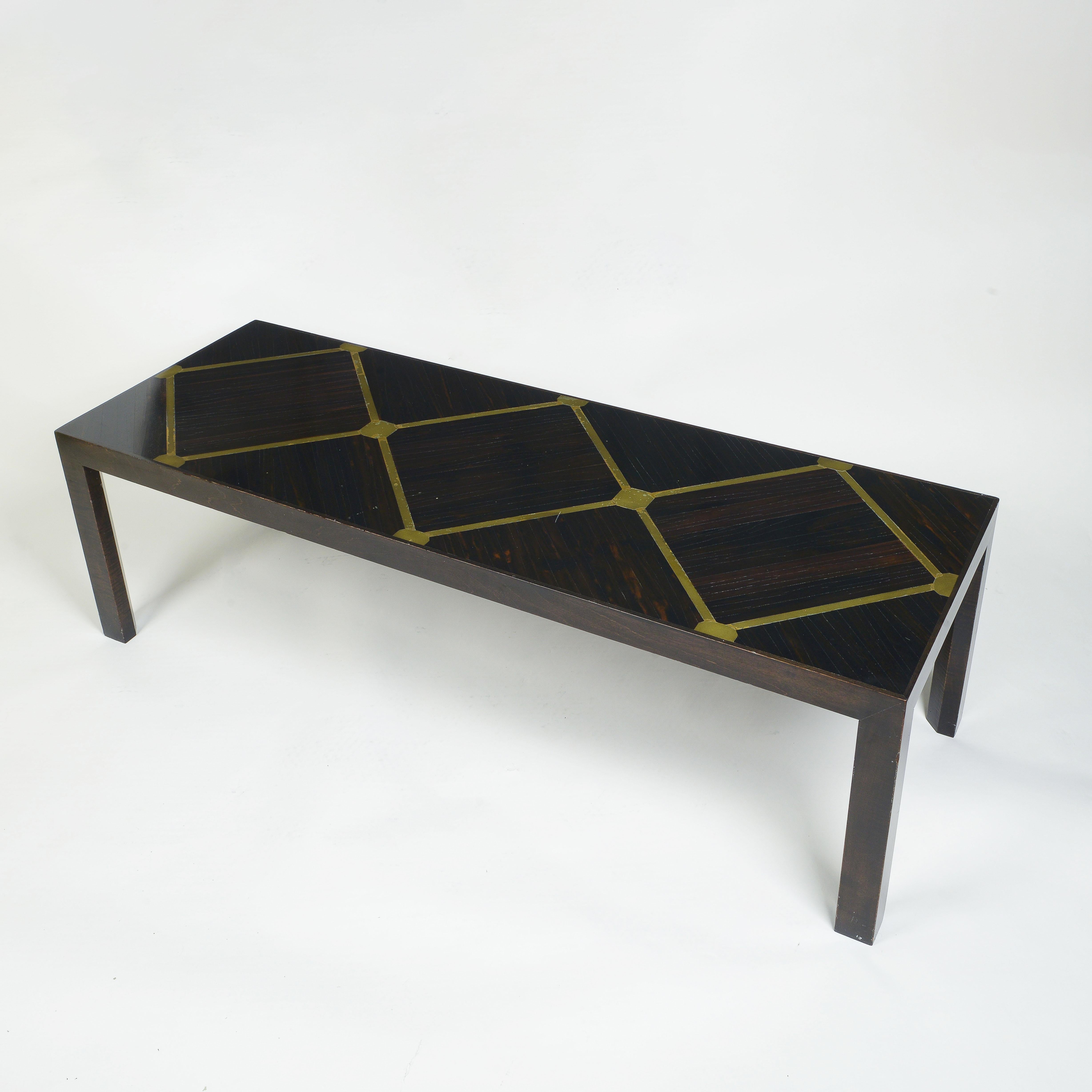 The long rectangular top inlaid into the rosewood with brass in a trellis design; raised on four square straight legs.