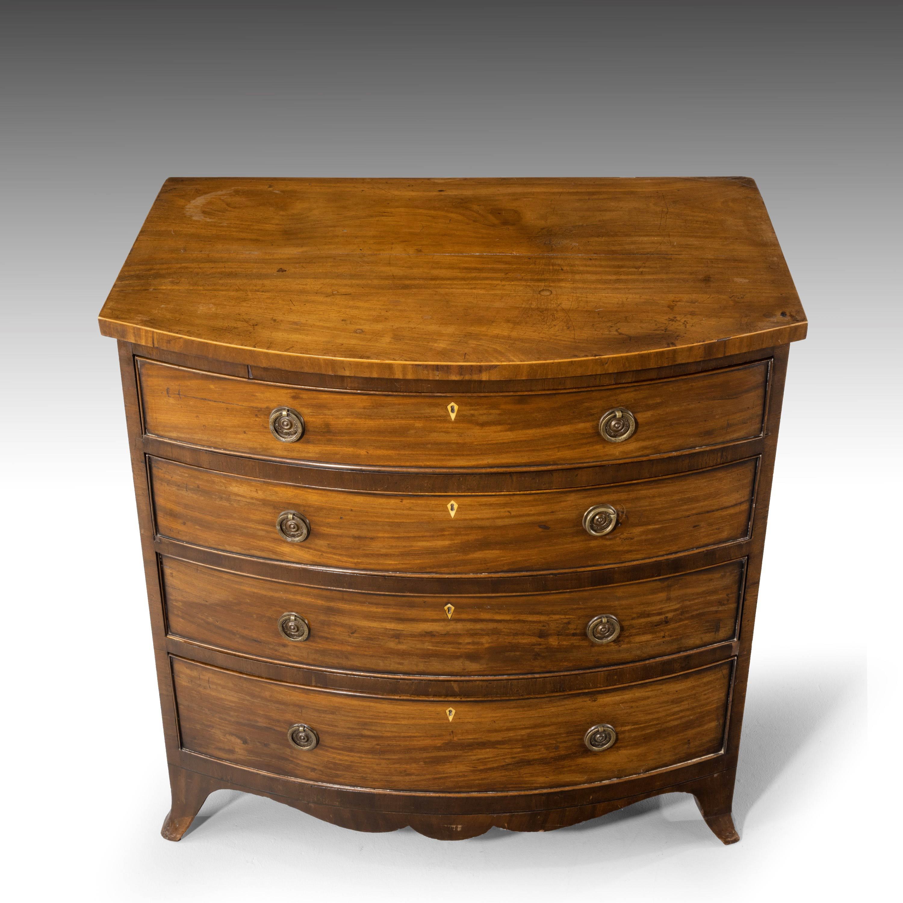 A particularly good George III period bow-fronted chest of drawers. With a strongly D-shaped front. Attractive high swept feet with minor repairs to the bottom two inches. A carcass split to the top, not to be restored, totally acceptable wear and