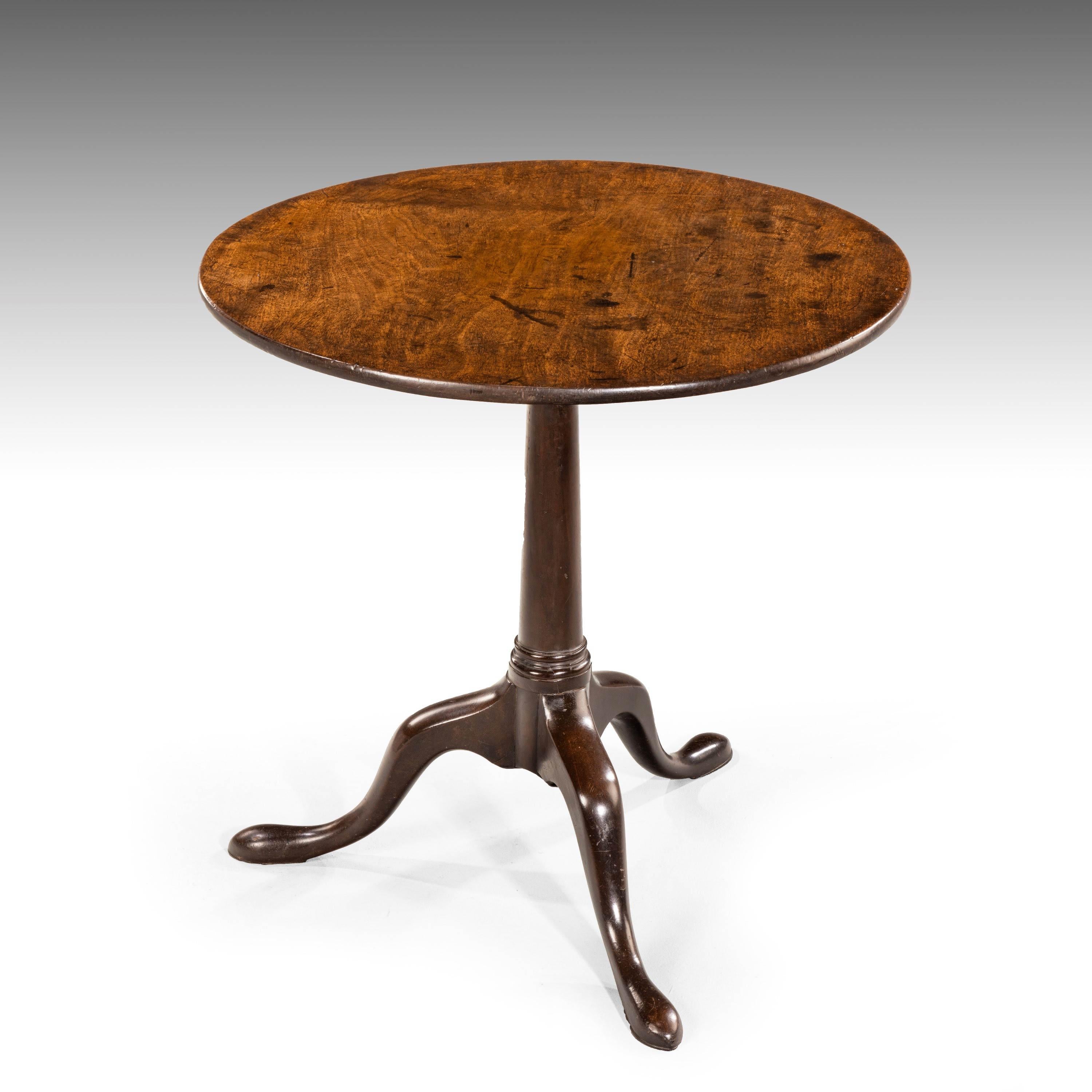 A particularly good and patinated George III period mahogany tilt table. On a gun barrelled support with three pad feet.
 