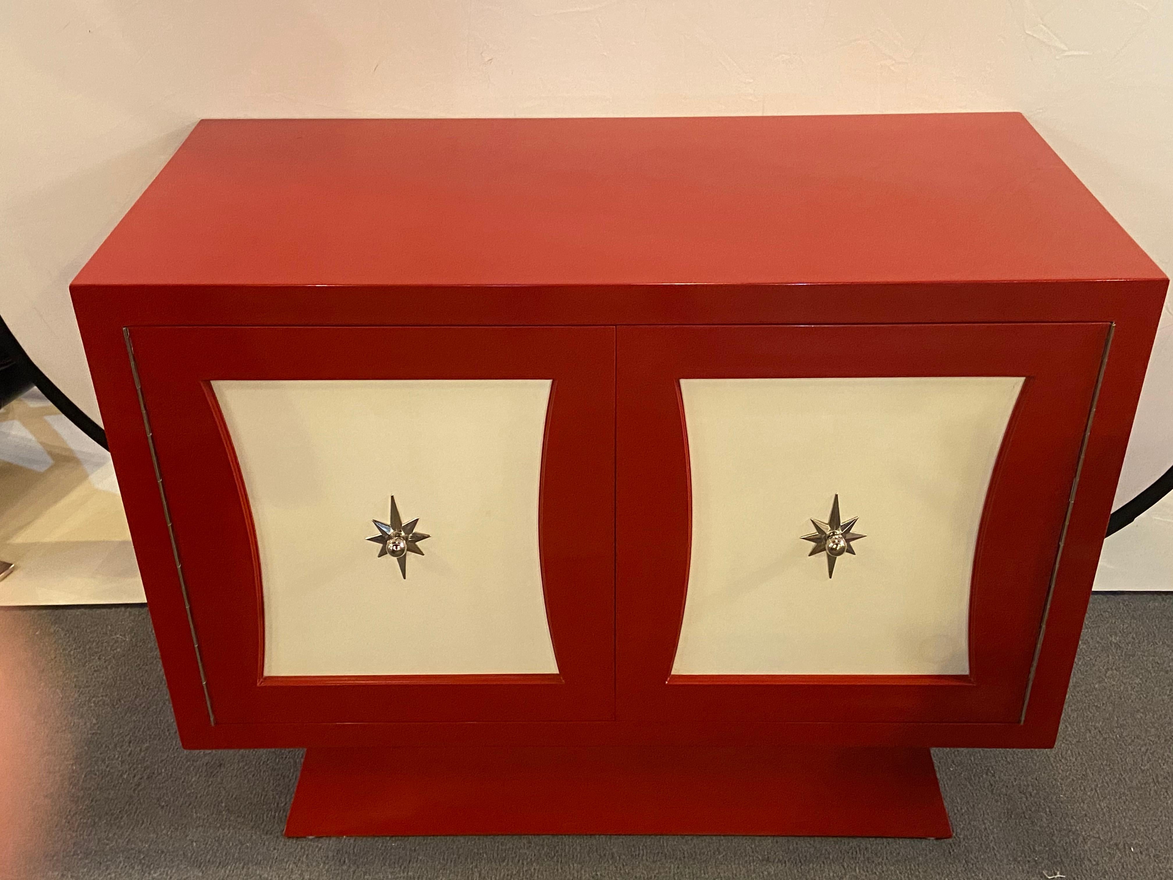 A  Mid Century Modern style Parzinger style cabinet, commode or server lacquered in red and white
A two-door fire-engine red and white lacquered Parzinger style cabinet. The stylish Mid-Century Modern cabinet features three custom fitted interior