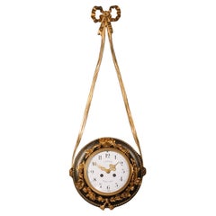 A Patinated and Gilt-Bronze Hanging Clock