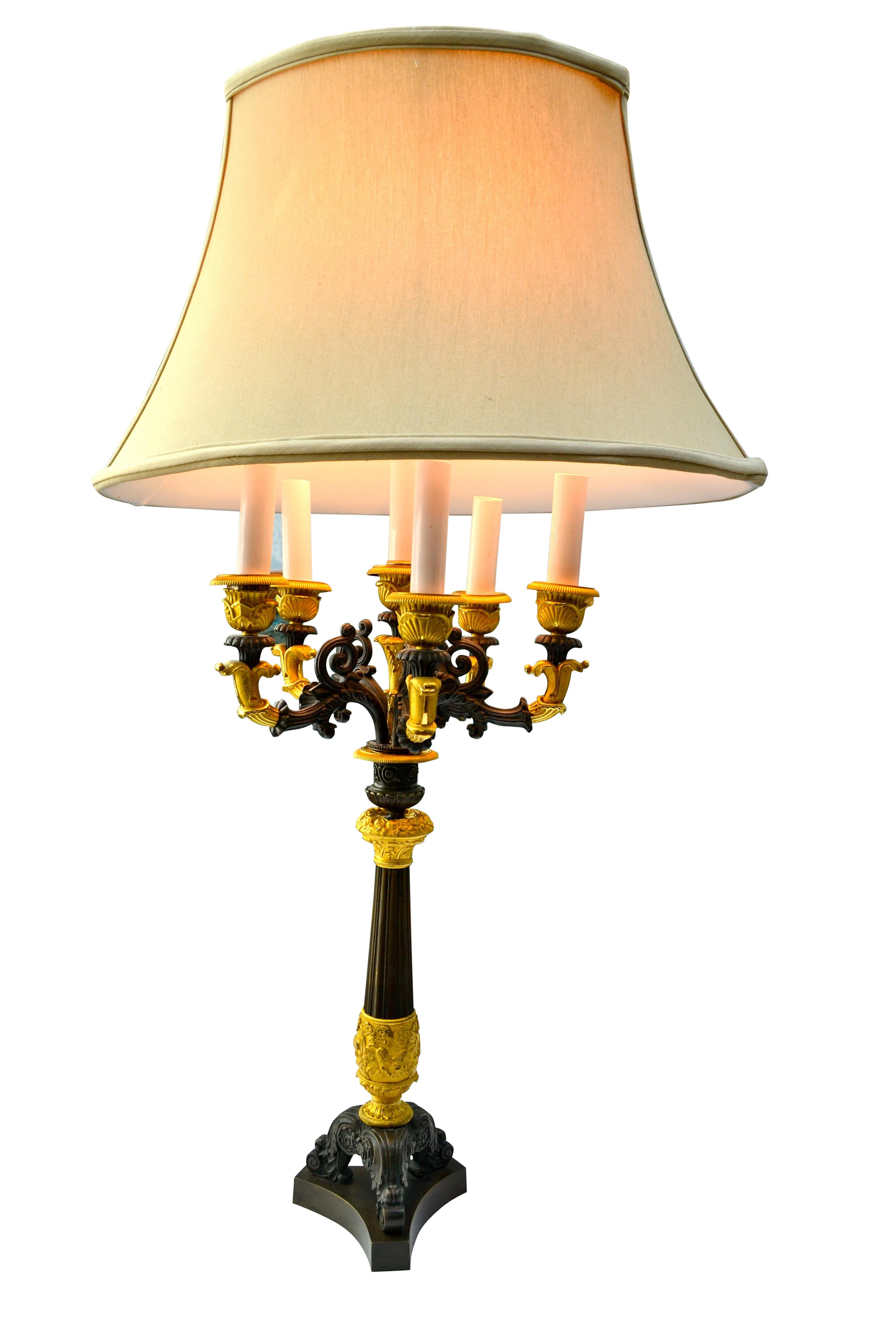 A patinated and gilt bronze six candle French Empire candelabra that has been converted into a lamp.