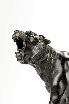 A patinated bronze okimono of a roaring tiger, signed Maruki Company and Atsuyos