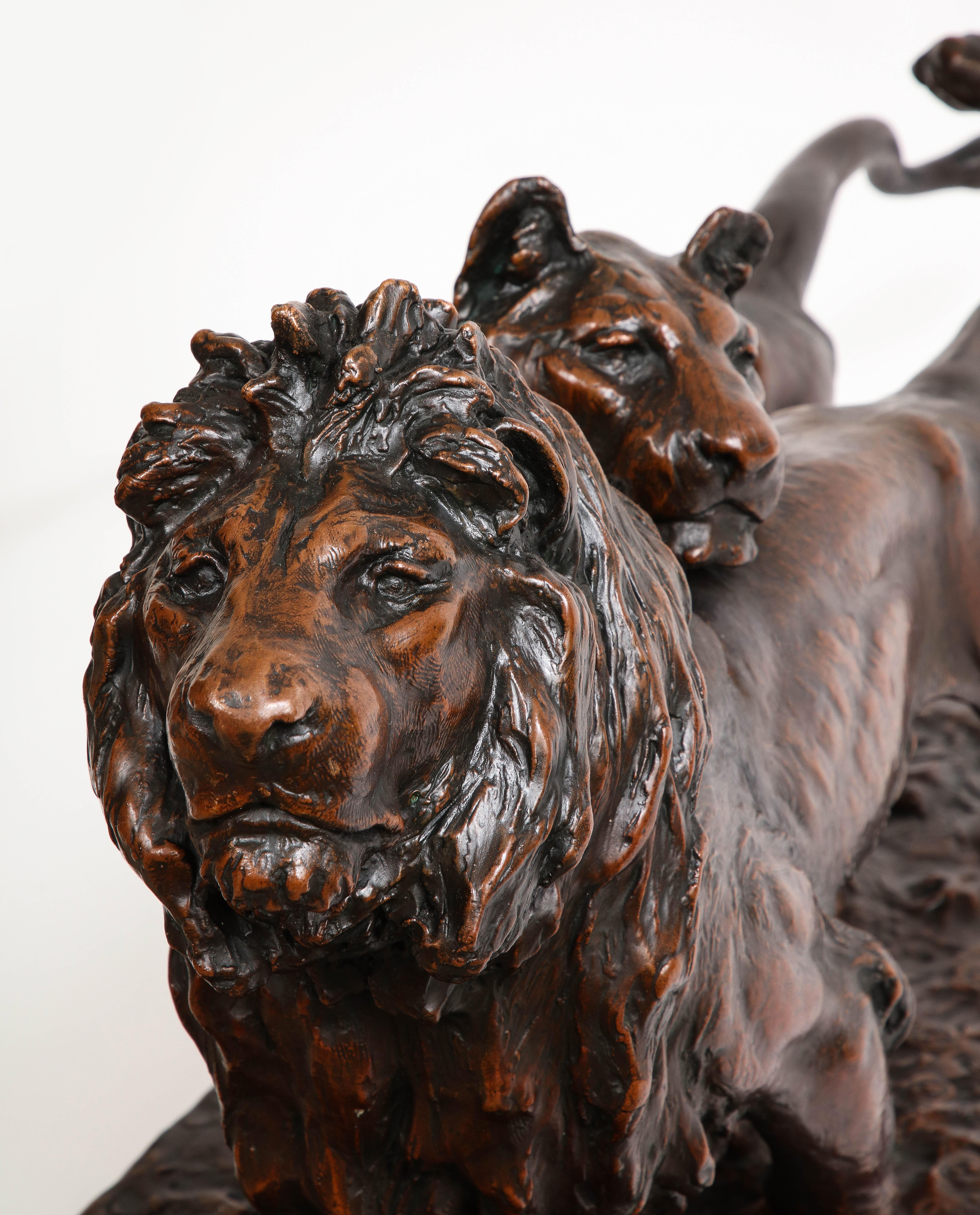 A Patinated Bronze Sculpture of Two Striding Lions, Signed By the Artist For Sale 6